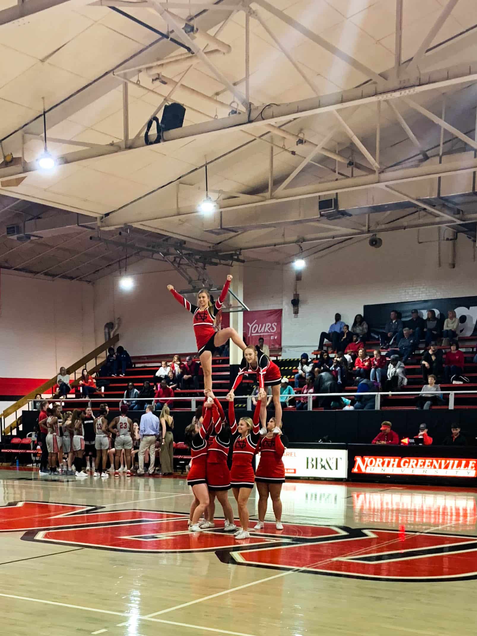 After the first quarter, the NGU cheerleaders perform a stunt at half court.