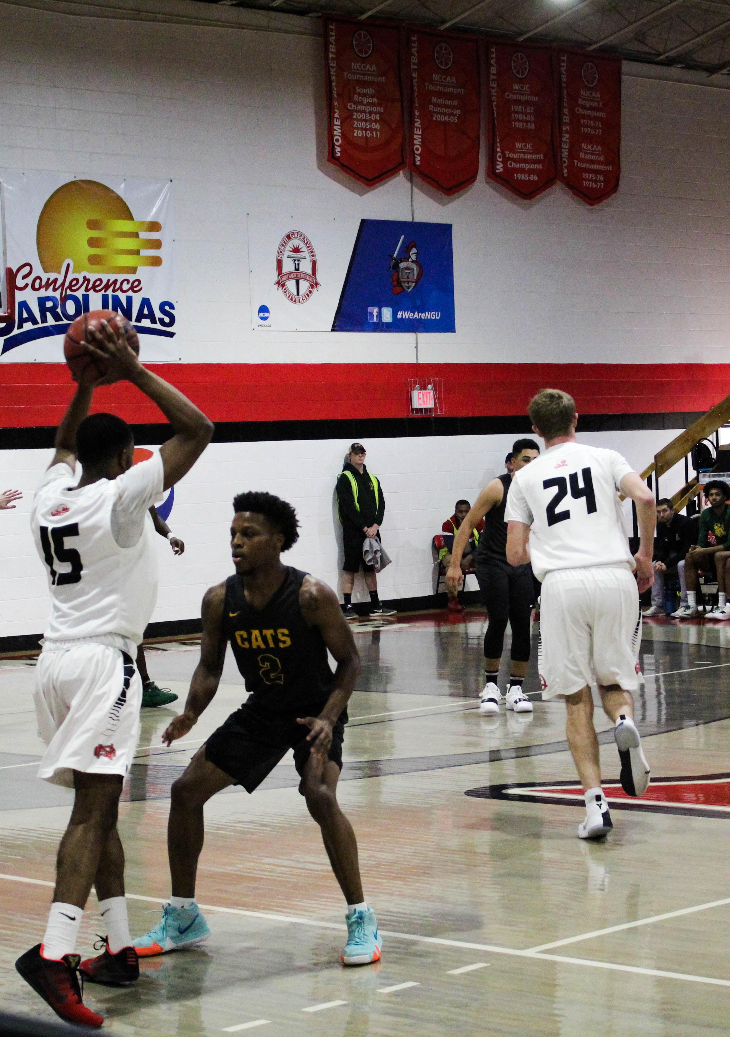 Sophomore Ryan Mobley (15) looks for a teammate to pass the ball to while being guarded.