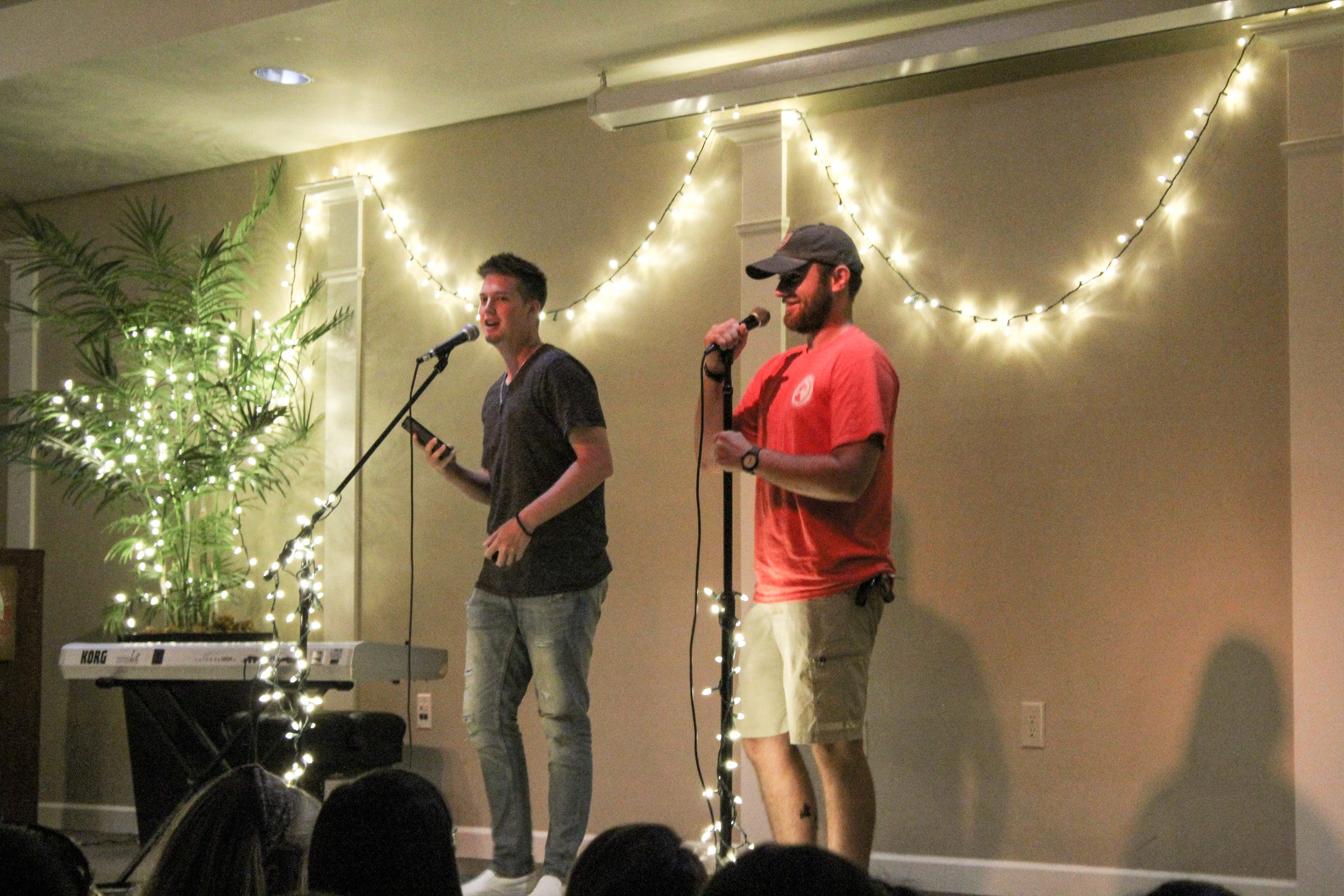 Seniors, Taylor Brunson and Jon Fordree, also the announcers of the coffeehouse, make jokes to keep attention on the stage as the next act makes their way to the stage.