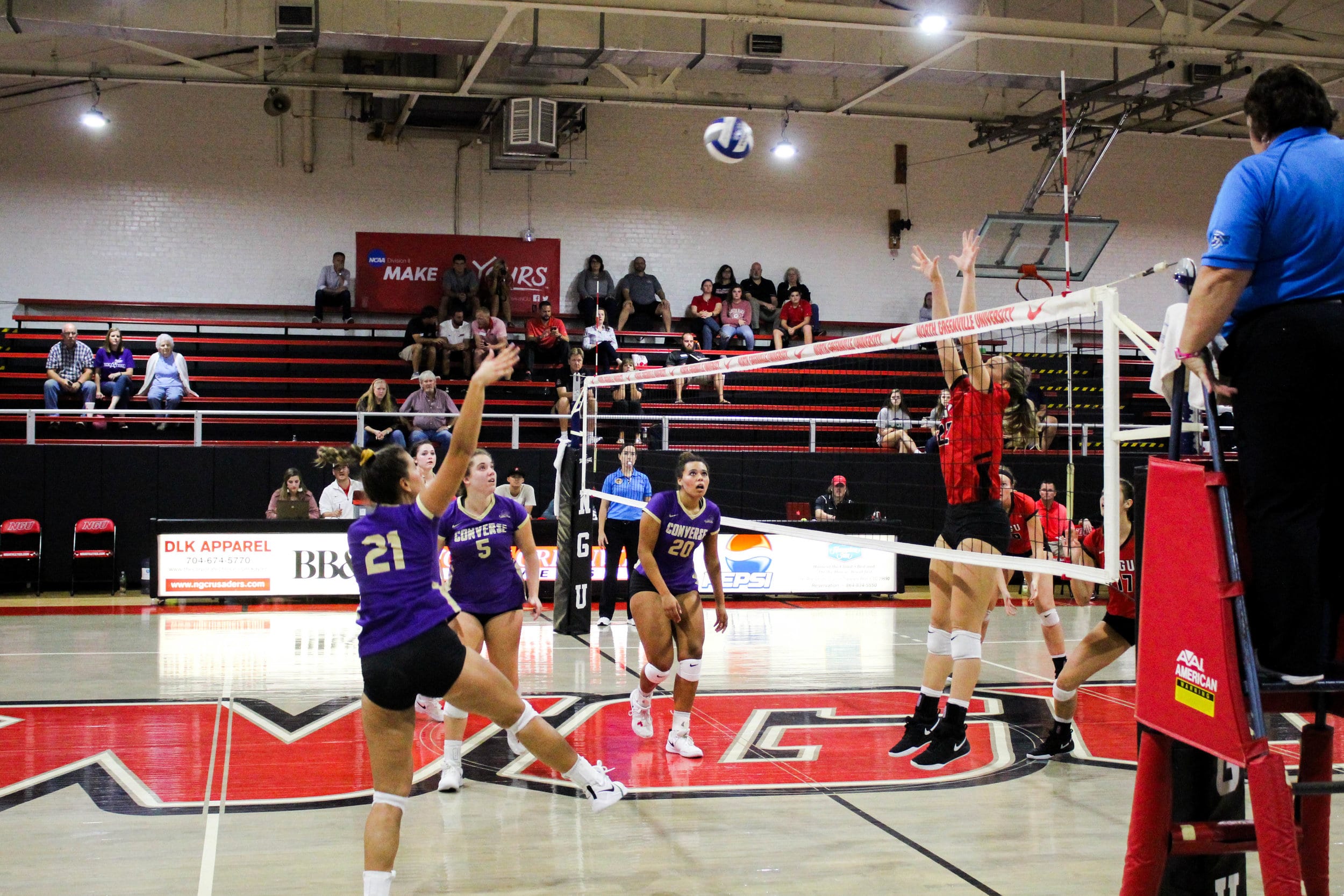 Senior, Courtney Williamson (22), jumps as she prepares to block a hit across the net.