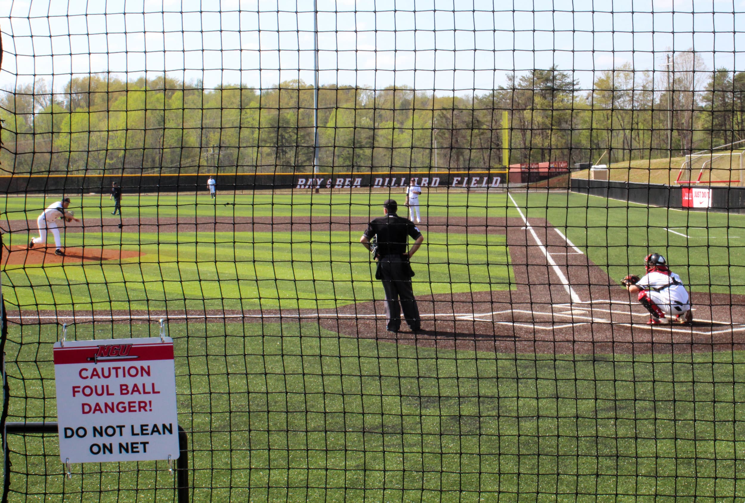 Pitcher Tucker Burgess warms up by throwing to the catcher as the batter from Limestone gets ready to come to the plate.