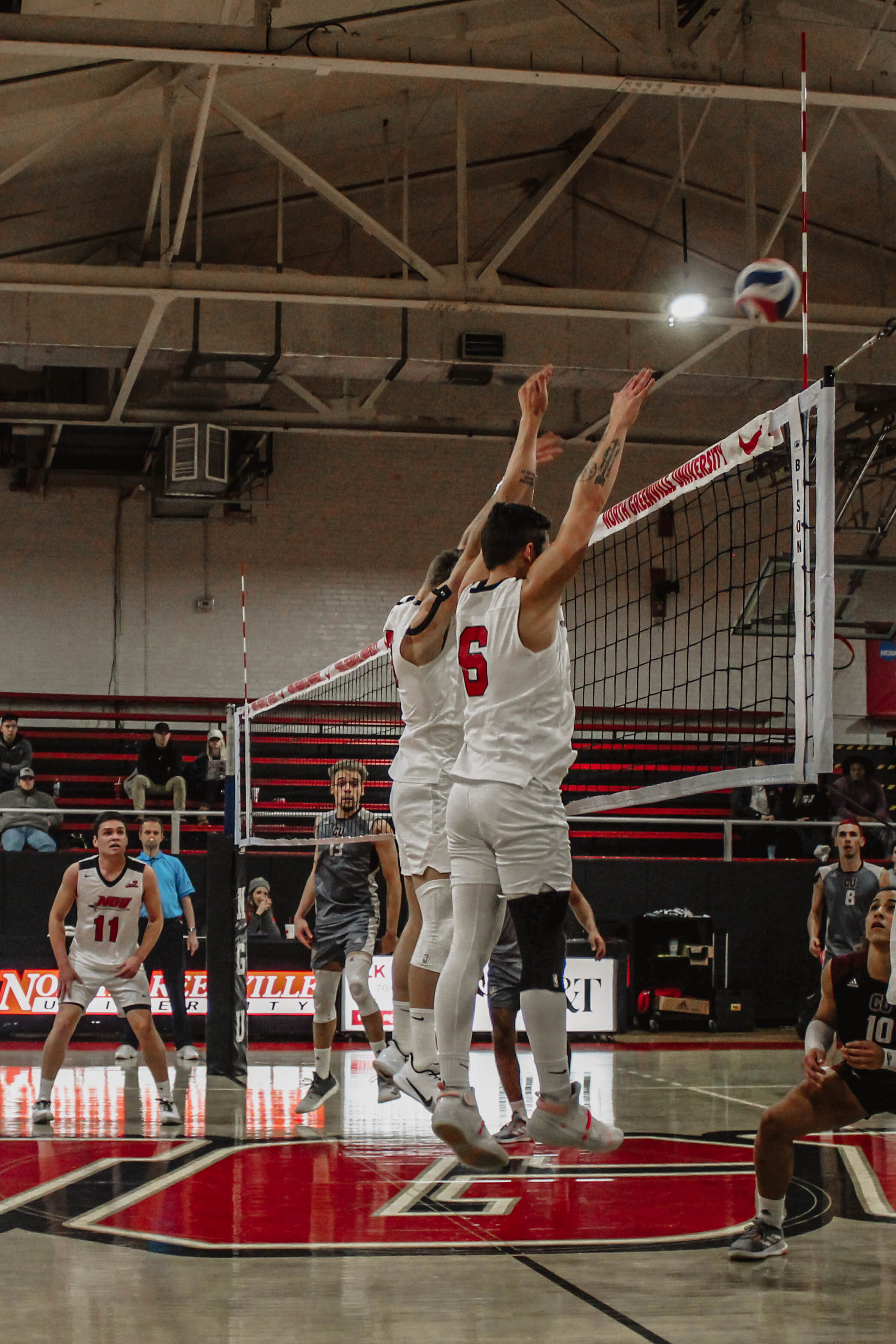 Seniors Jake Boldog (6) and Ben Hamsho (13) jump together to block the ball hit over the net by a Campbellsville University player.