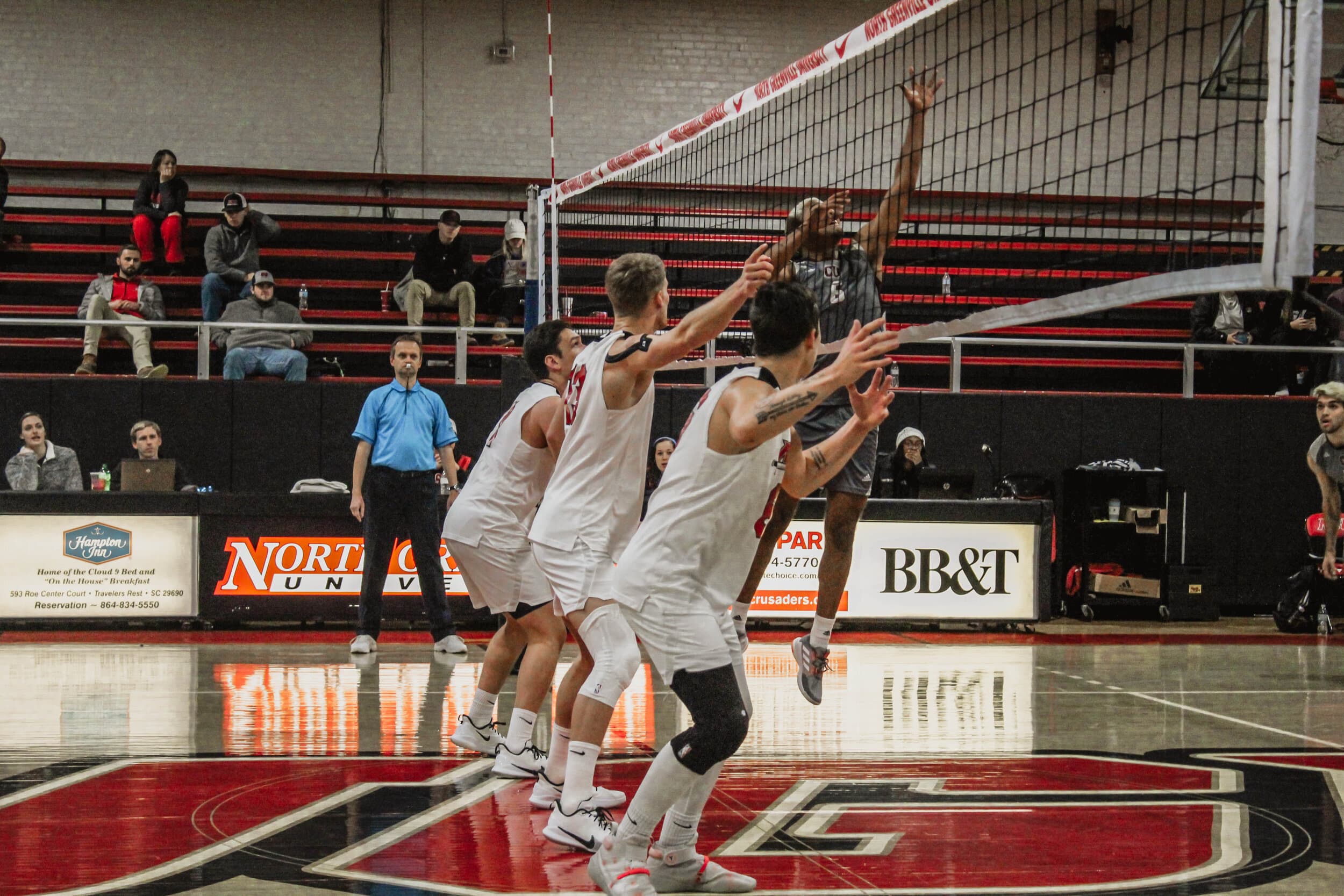 Sophomore Cade McGee (11), Jake Boldog (6) and Ben Hamsho (13) prepare to return the ball over the net as a Campbellsville player hits the ball over.