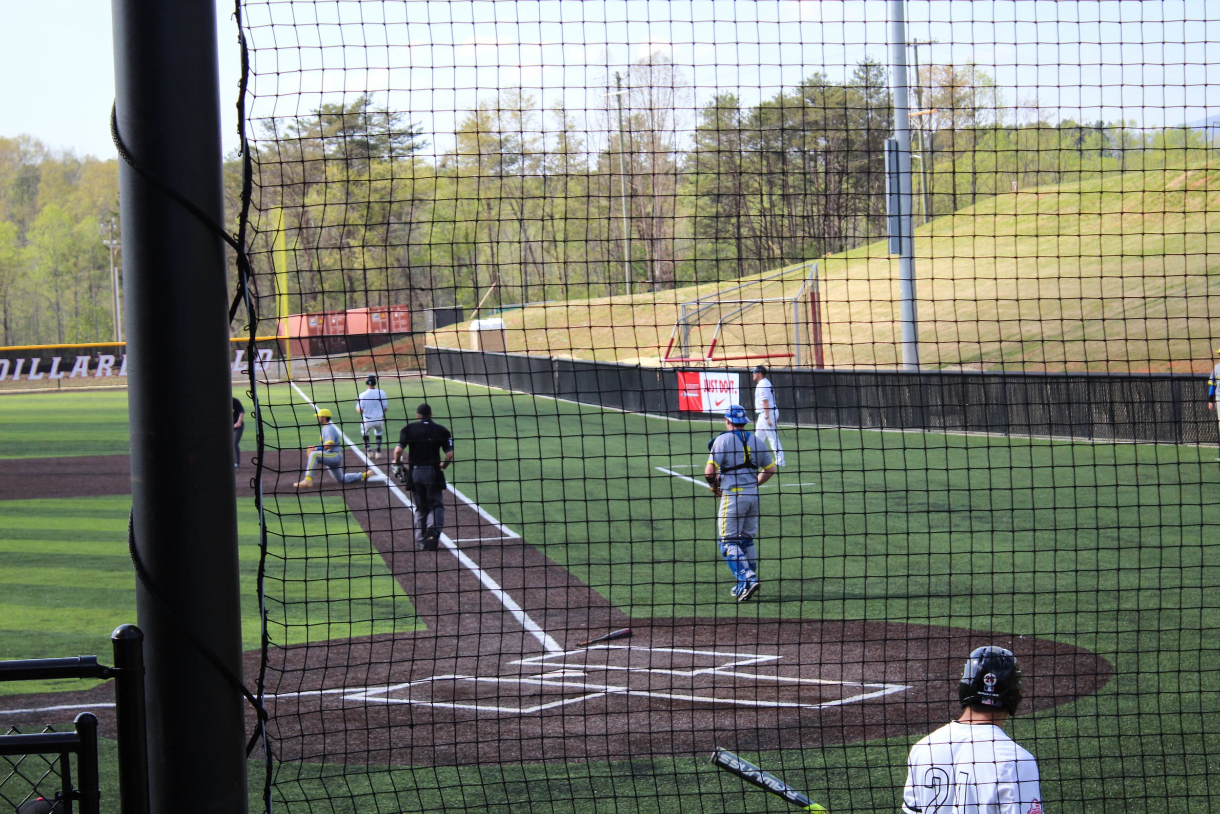 Grant runs through first base as the first baseman for Limestone attempts to get him out.&nbsp;