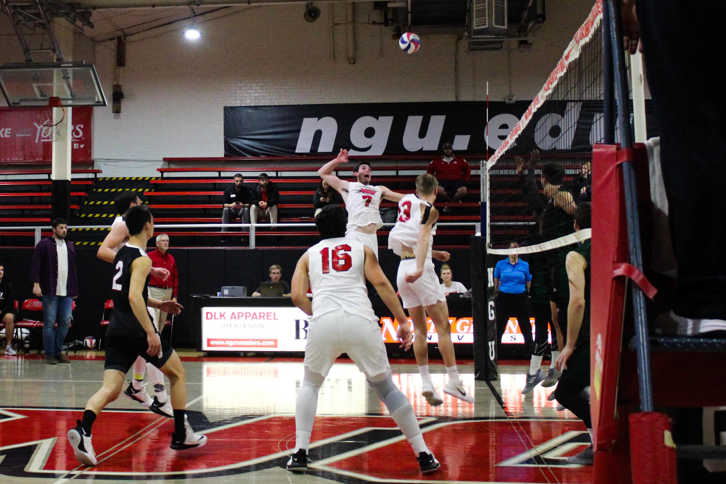 Junior Jackson Gilbert (7) leaps to spike the ball over the net onto Mount Olives side.