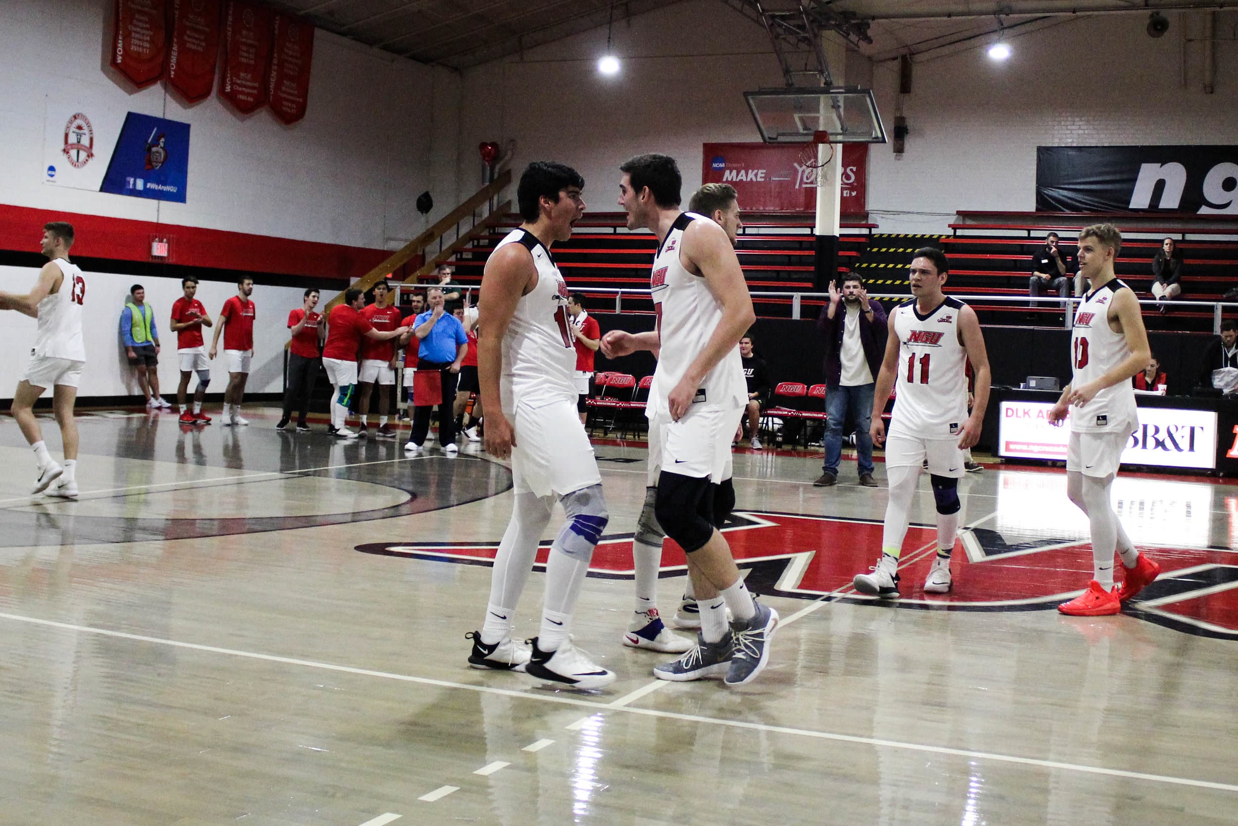 Freshman Sergio Carrillo (16) and junior Jackson Gilbert (7) celebrate together after Carrillo scored a point for the team.