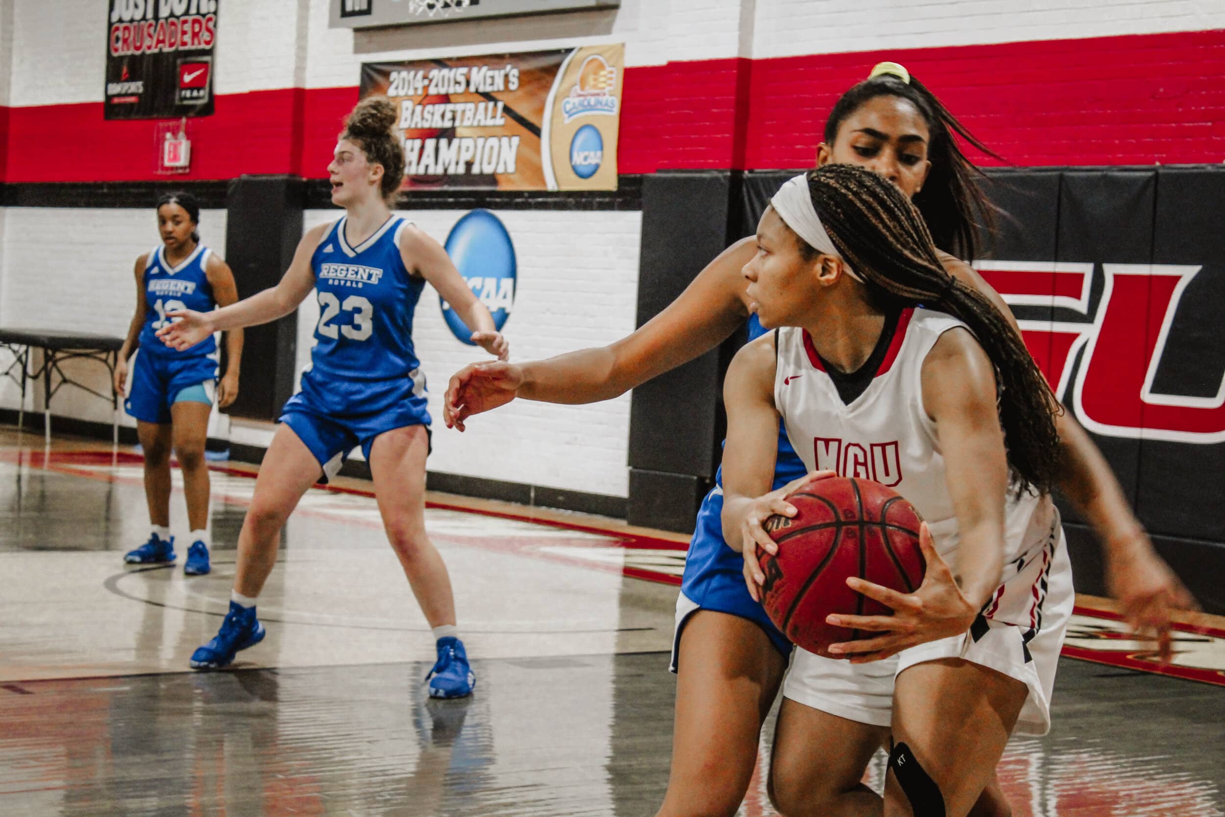 While on offense, guard Damiya Montgomery (11), looks for a teammate to pass to as she is corned by a defender.