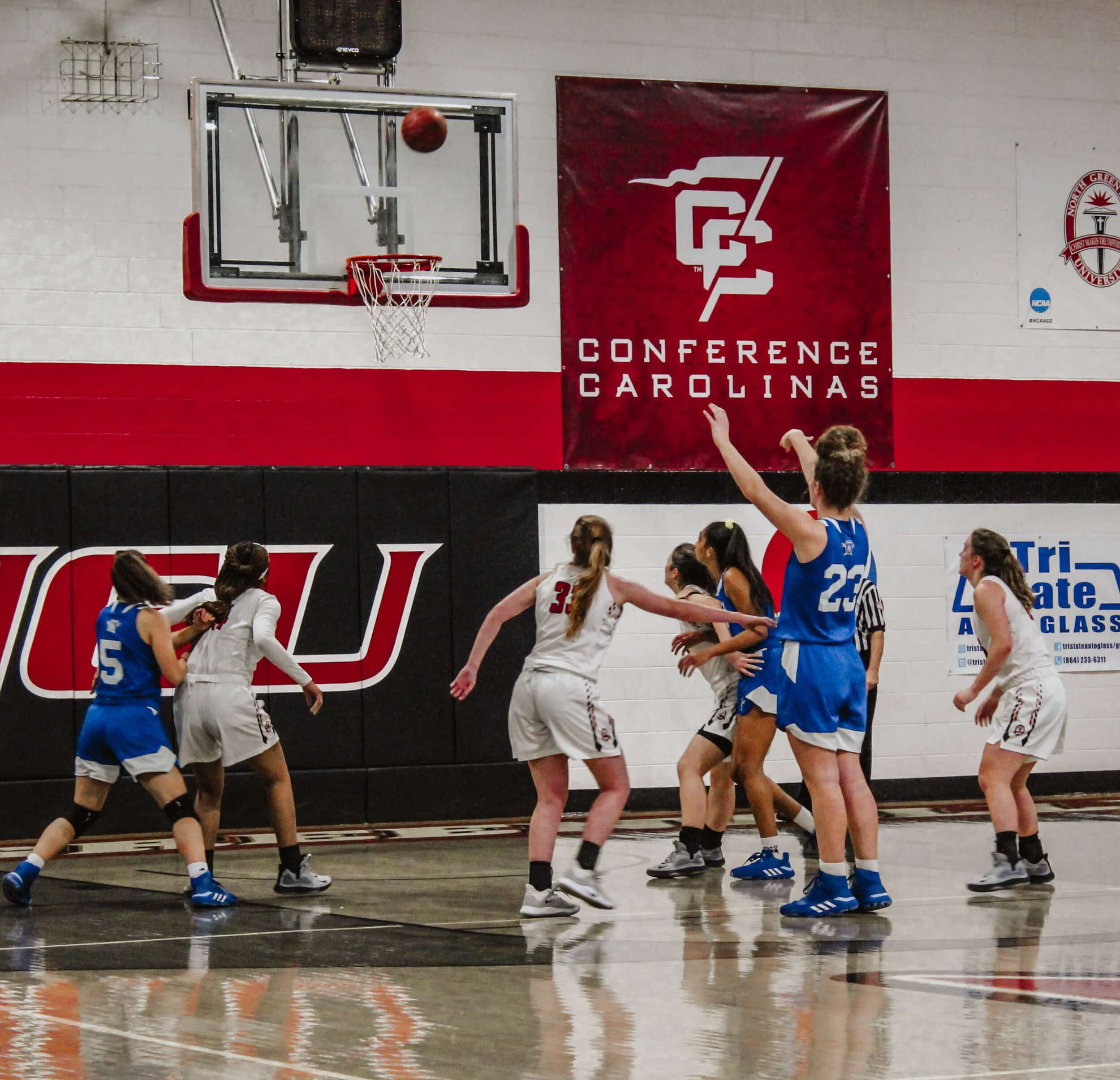 The NGU womens basketball team box out the Regent Royals after a Regent player shoots a free throw.