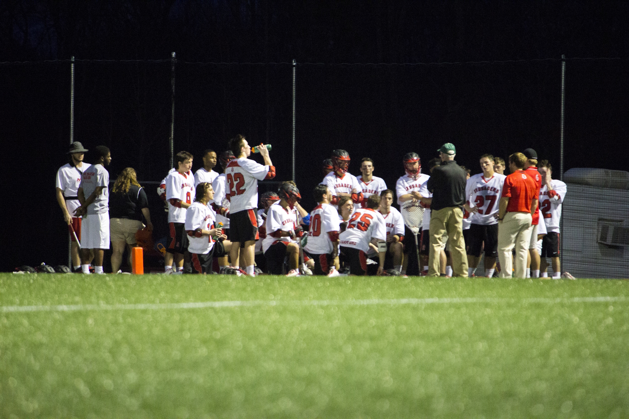  The team gathers up to get encouragement and feedback on the game from their coaches.&nbsp; 