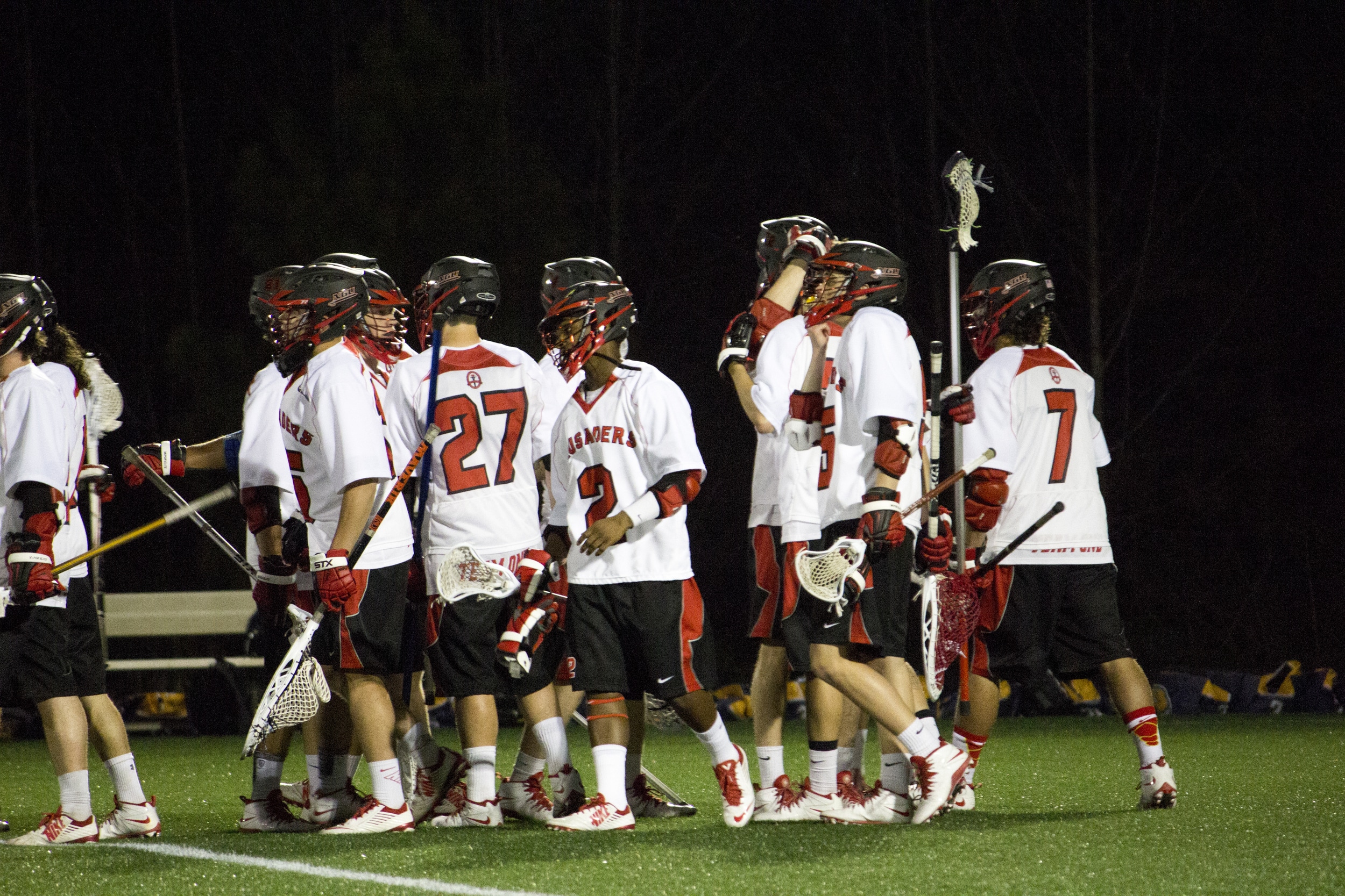  At the end of the match, NGU's lacrosse team gathers together to encourage one another after their defeat and shake hands with the other team.&nbsp; 