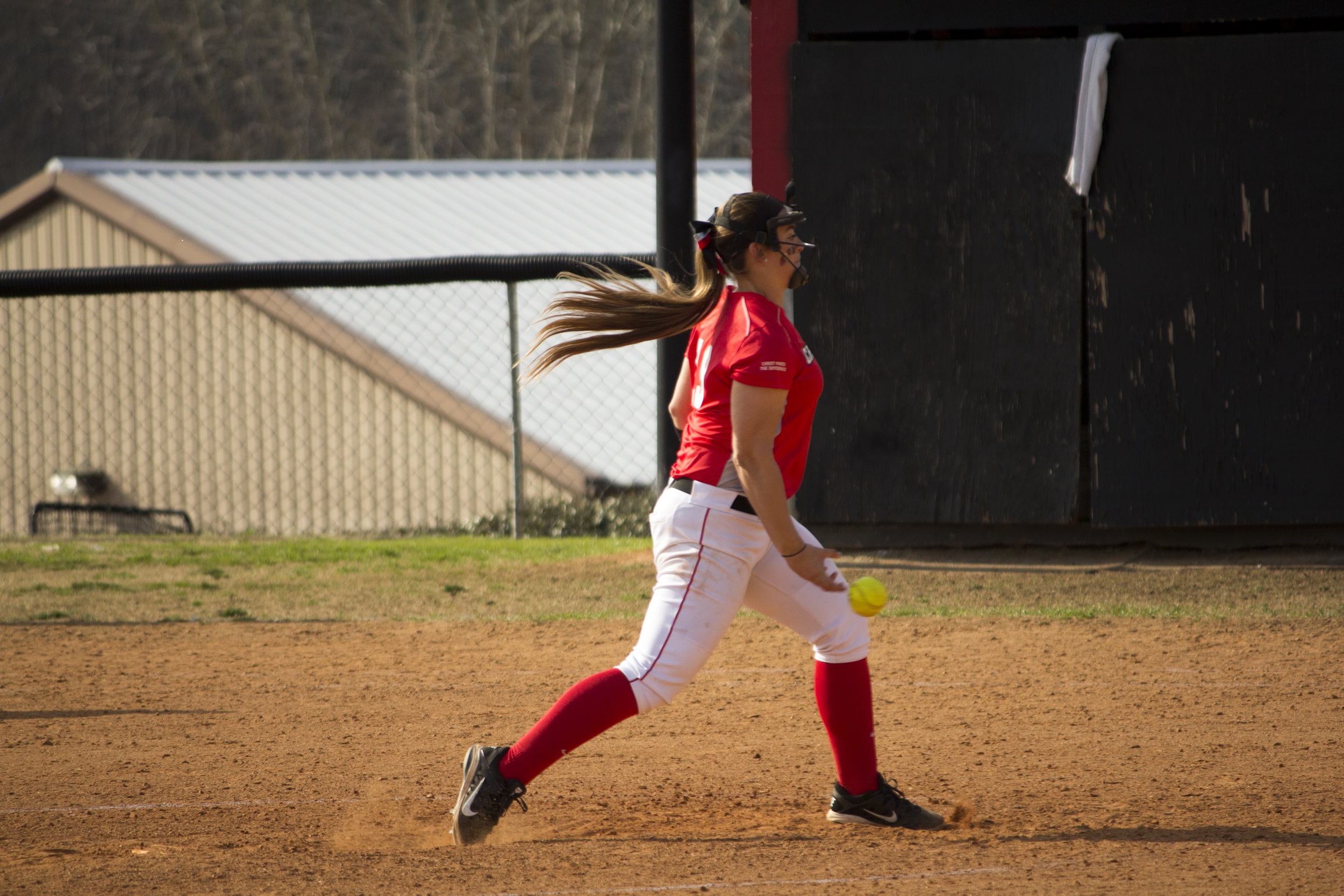  Freshman Emily Murphy pitches the ball towards the rival batter in hopes for a strike. 