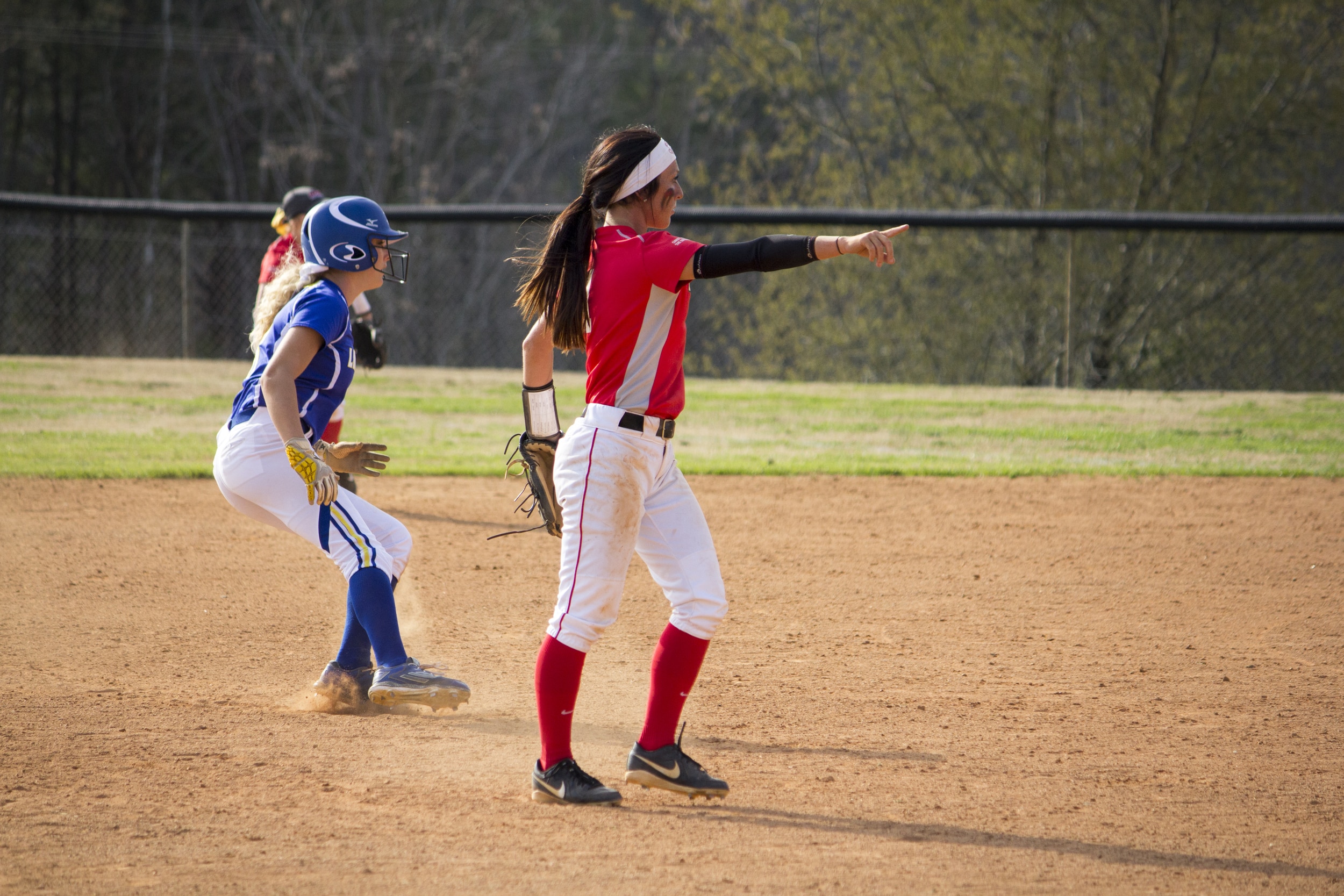  Sophomore Shayna Finley tells her teammates to keep&nbsp;an eye on third base.&nbsp; 