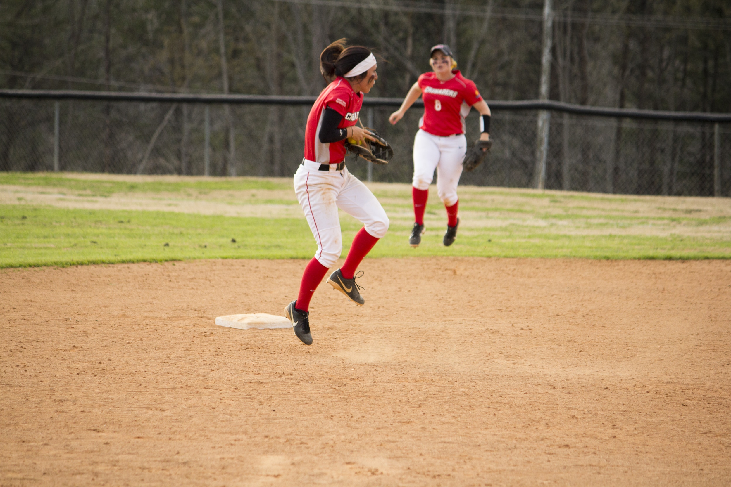  Sophomore Shayna Finley jumps up to stop the ball and throw it to first base.&nbsp; 