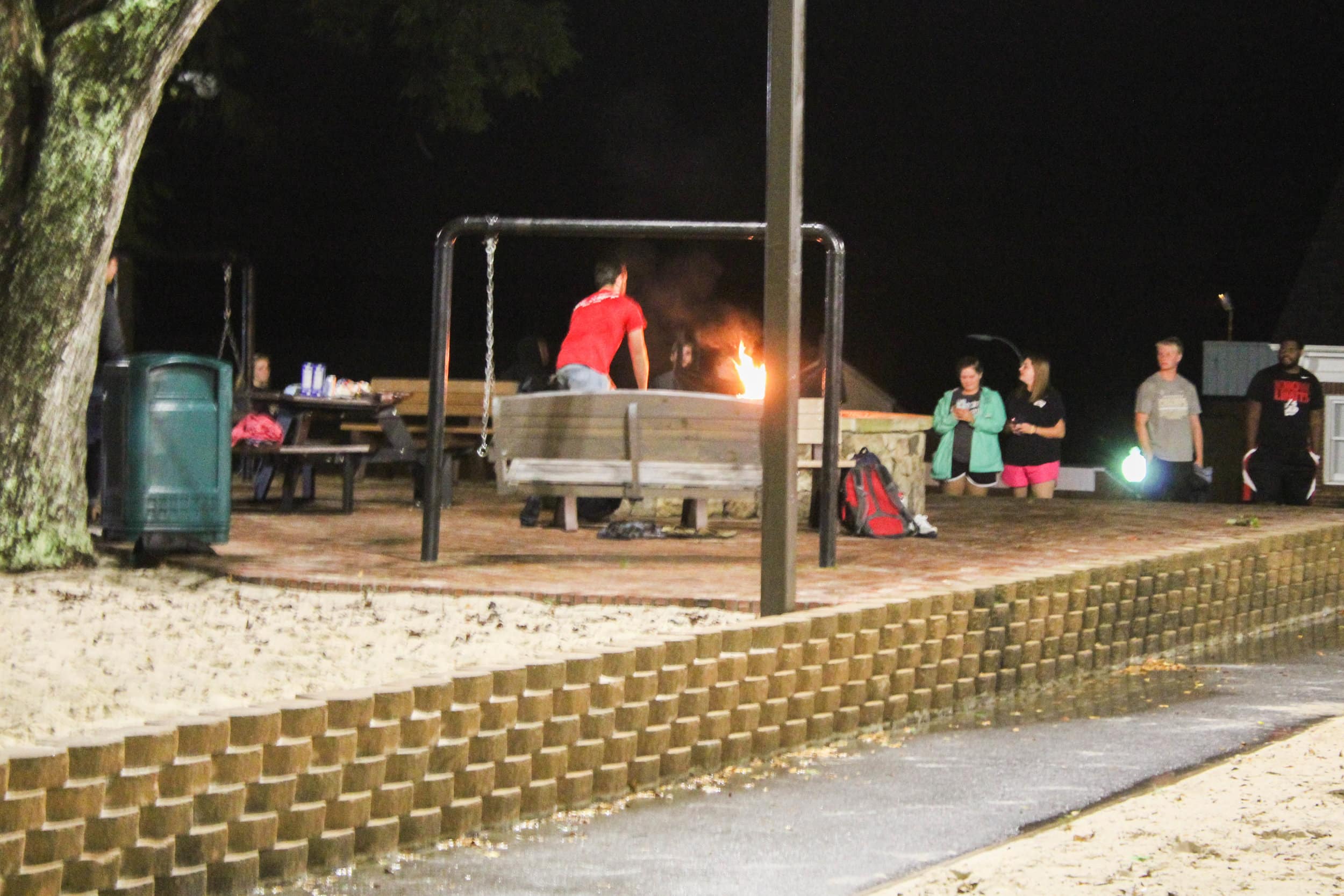 Senior, John Ross Fordree, runs with a torch to light the fire pit during the opening ceremony.