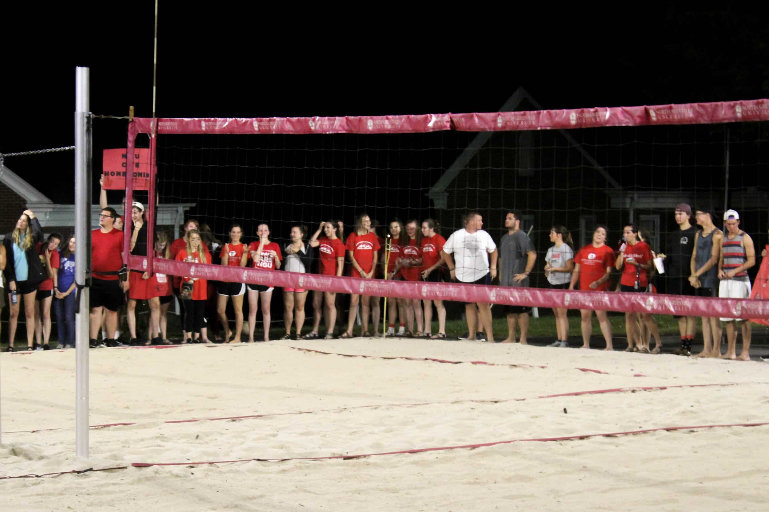Members of the College of Education show their support for their team by lining up and cheering.