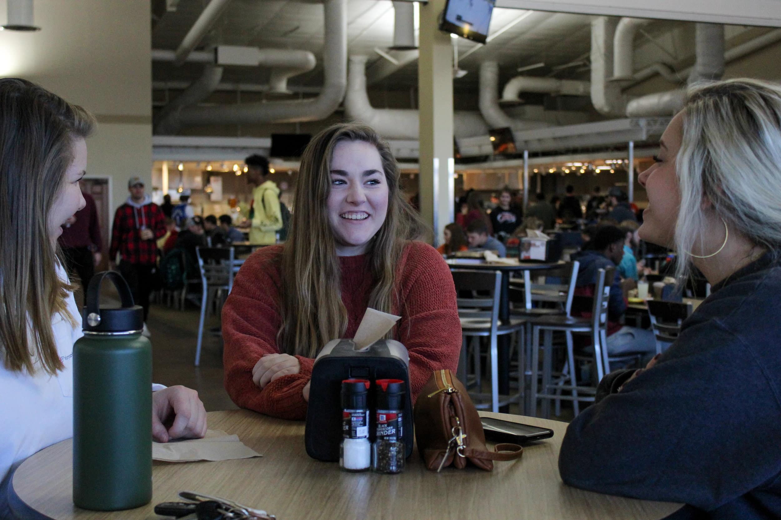 Freshmen Tess Shirley, Lauren Blackwell, and Abby Swindal socialize in the Caf before lunch.