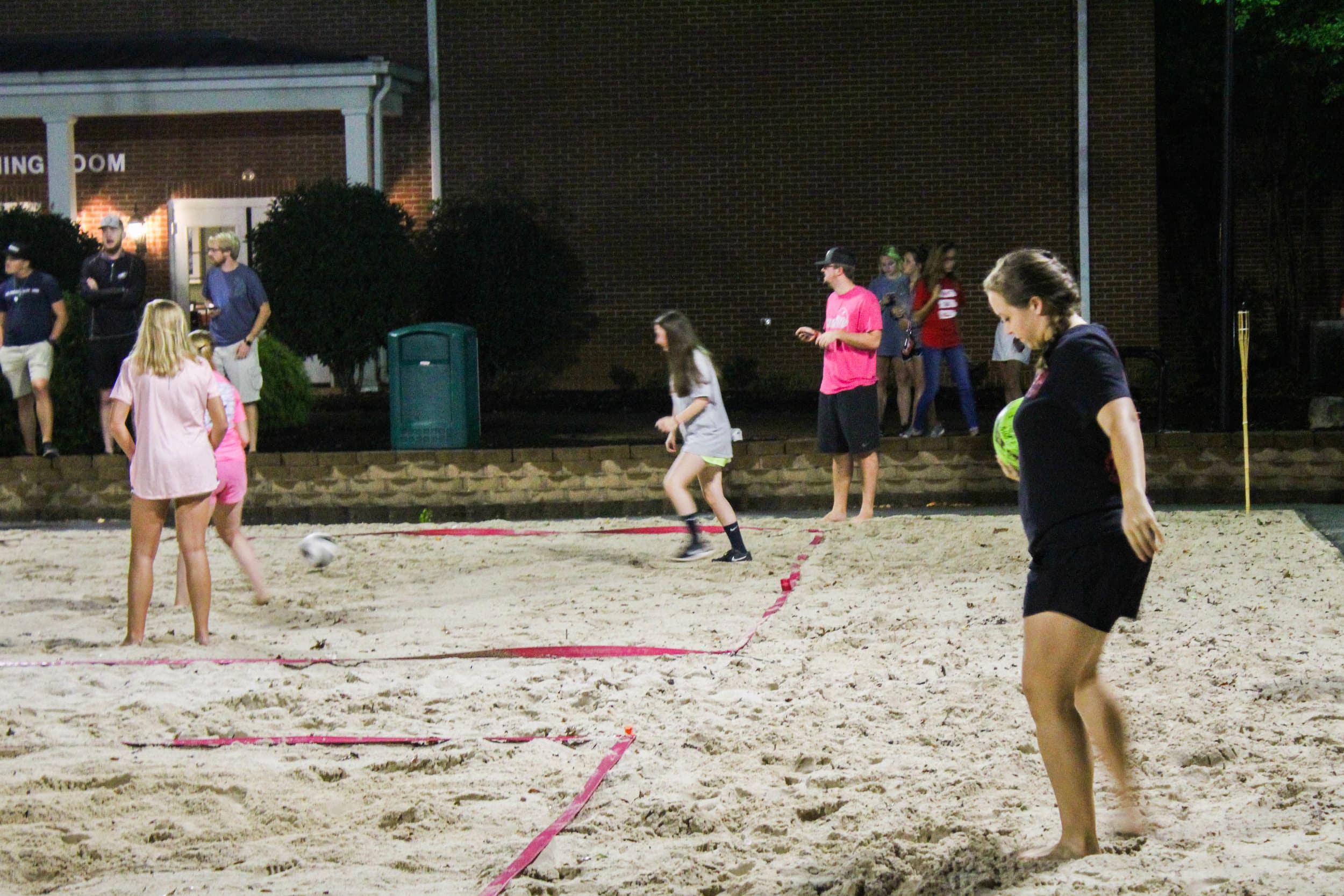 A member of the animal science club gets ready to serve the ball toward the campus ambassador team.