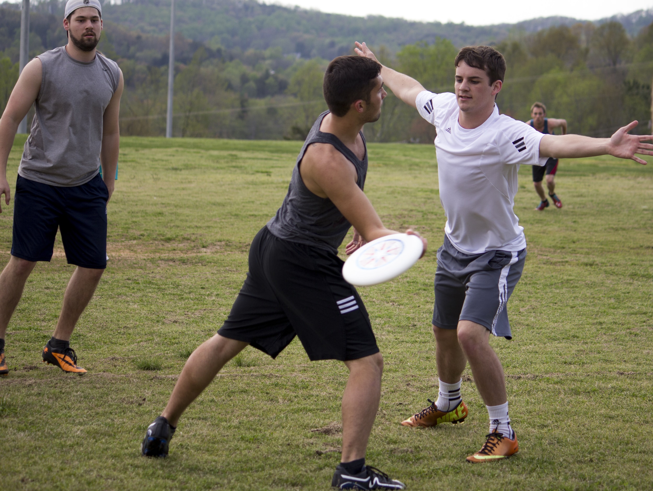  Josh Mckeown side steps to get around the other team member and make a play downfield.&nbsp; 