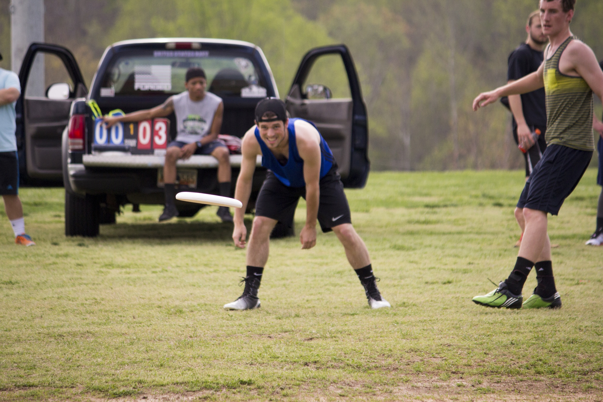  Daniel Shamblin watches his released frisbee as his teammate runs to catch it.&nbsp; 