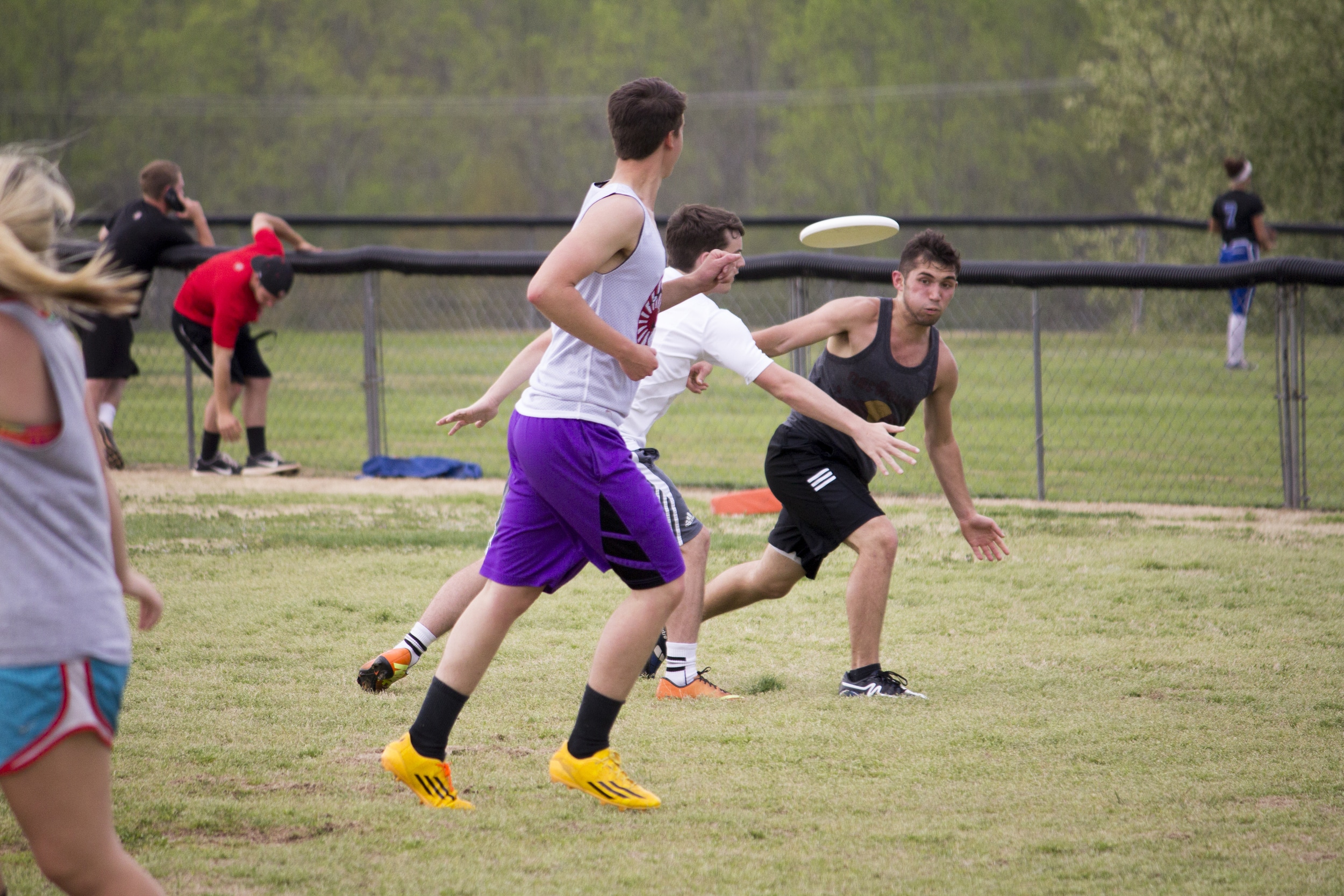  Josh Mckeown releases a throw past two opposing team members.&nbsp; 