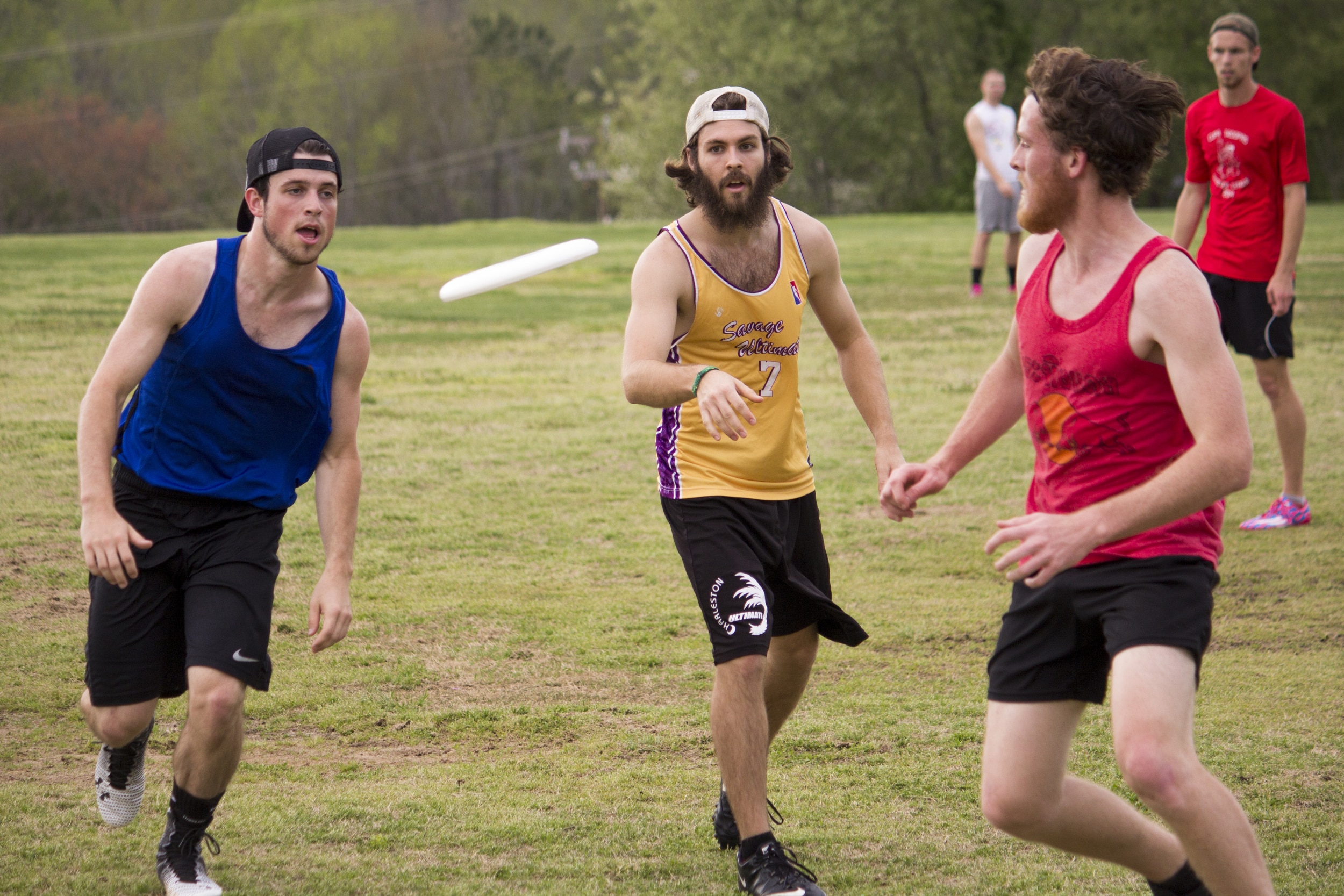  Three players race to the frisbee to&nbsp;obtain possession of&nbsp;it for their team.&nbsp; 