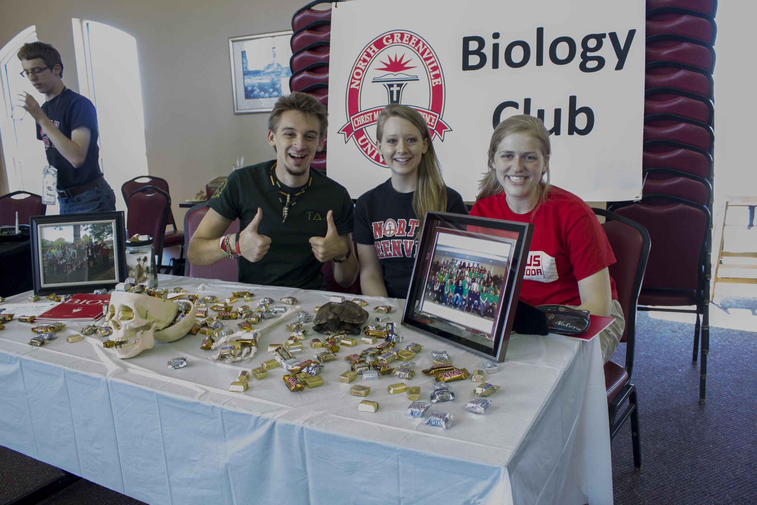  NGU biology majors give a thumbs up in regards to their&nbsp;booth.&nbsp; 