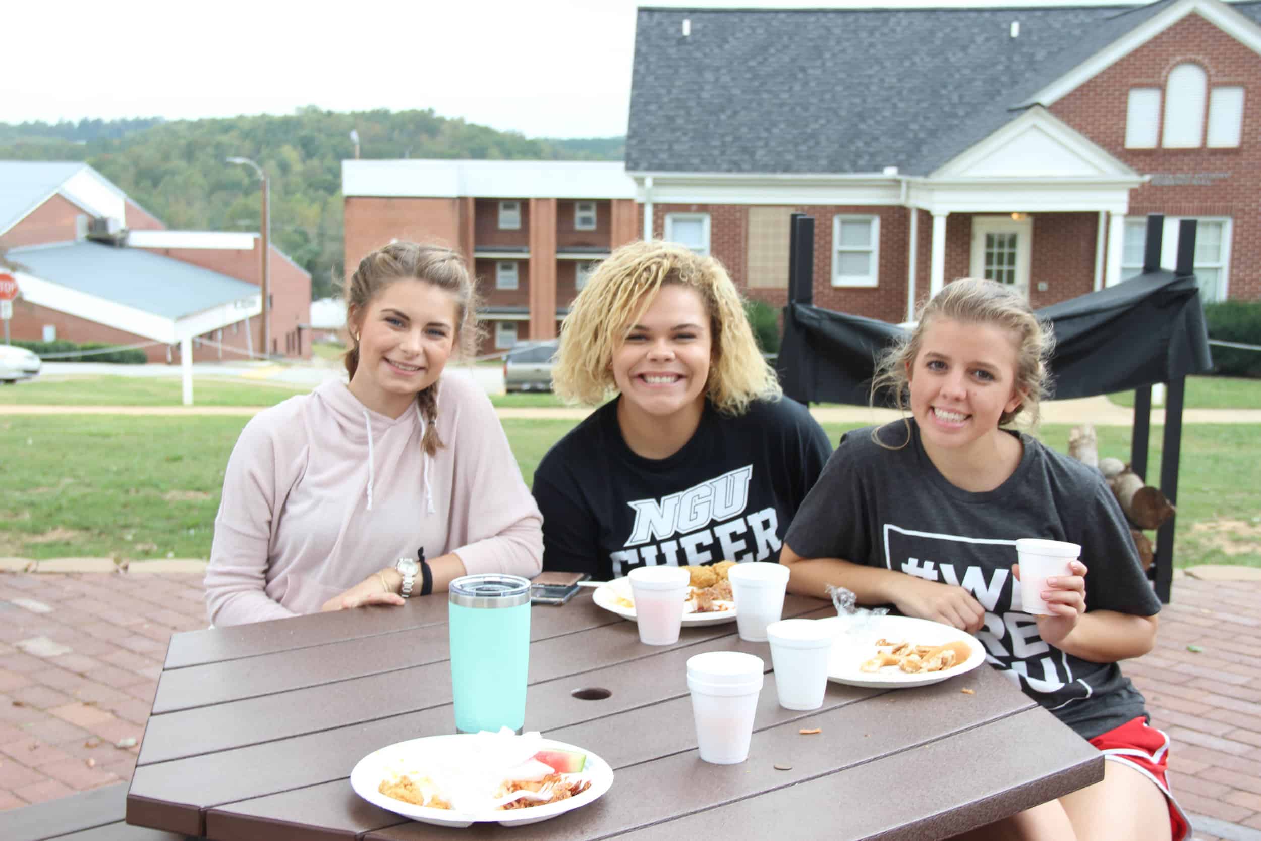 Harleigh Morrissey (Freshman), Dailyn Bradley (Freshman) and Amanda Fitzsimmons (Sophomore)&nbsp;having dinner by the bonfire.&nbsp;