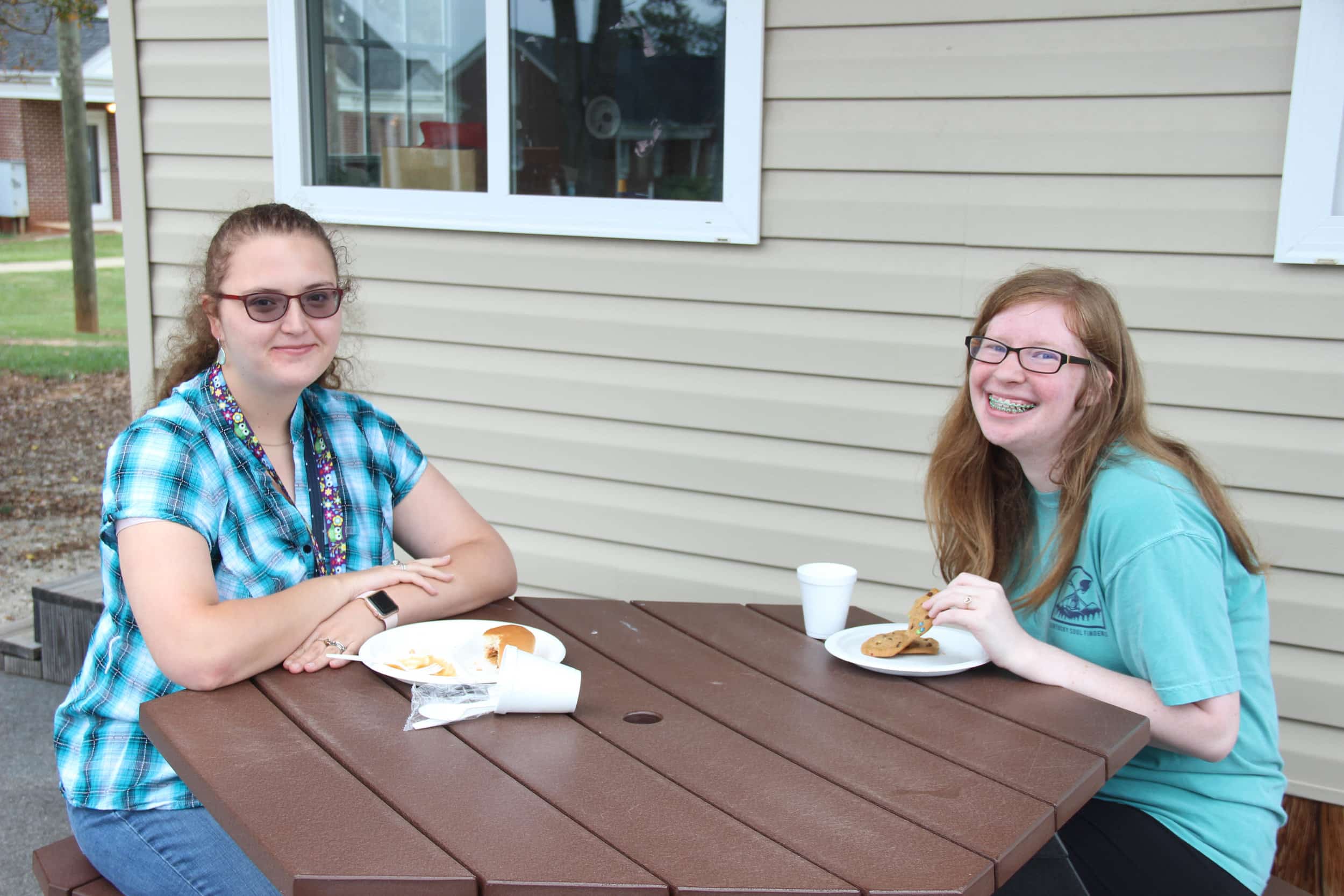 Savannah Mahaffey (Freshman)&nbsp;and Annie Holton (Sophomore) enjoying dinner at the Dinner and Bonfire.