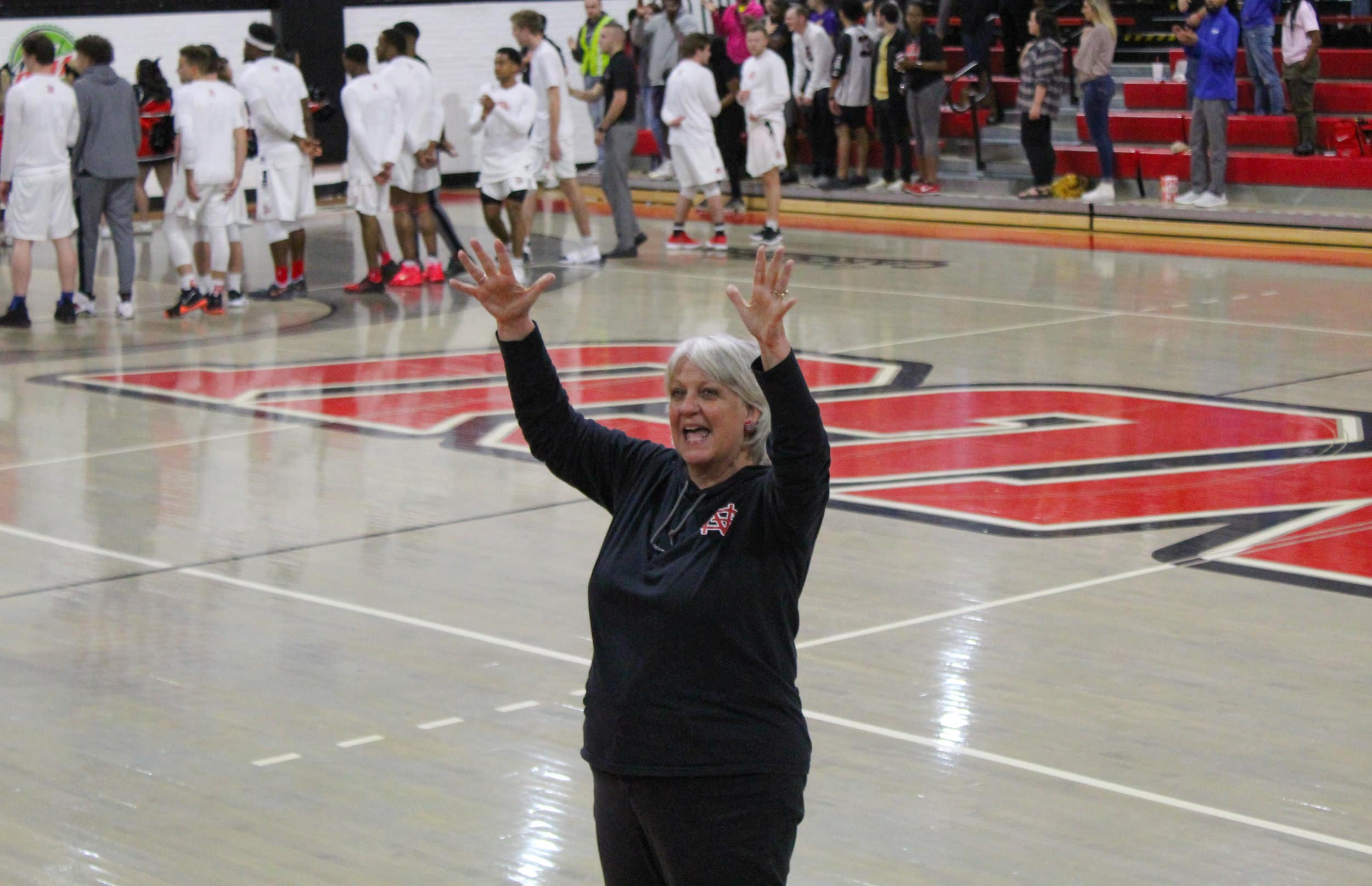 Professor Shannon Fike uses sign language to sign the National Anthem along side the students from the SC School for the Deaf and the Blind who came to visit.