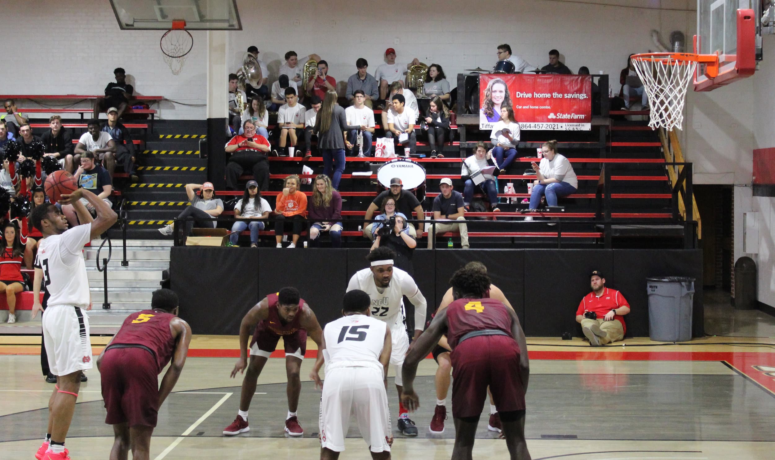 Tate, 3, shoots from the foul line alongside his teammates sophomore, 15, Ryan Mobley, and senior, 22, Roderick Howell anticipating to get the rebound.