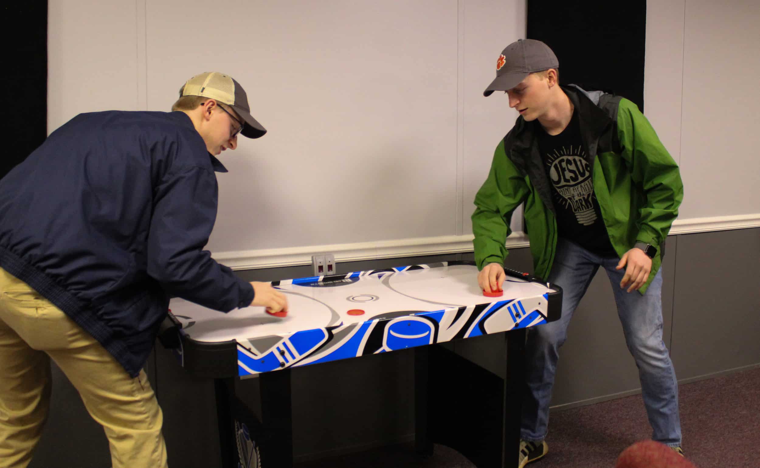 Youth leaders Will and Nathan Ingle brawl in a game of air hockey.