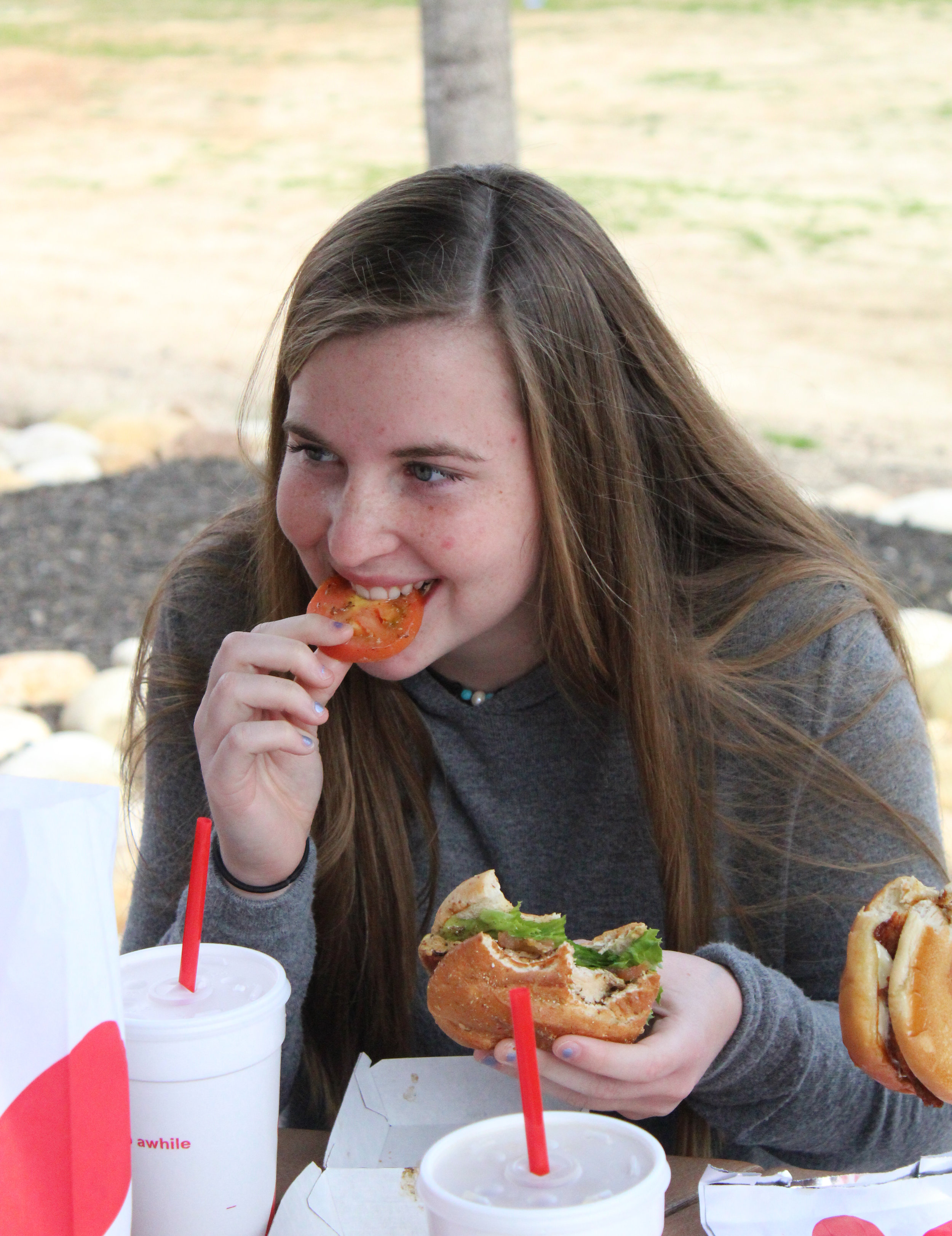 Freshman, Kaitlinn Harrison, makes her friends laugh during lunch.