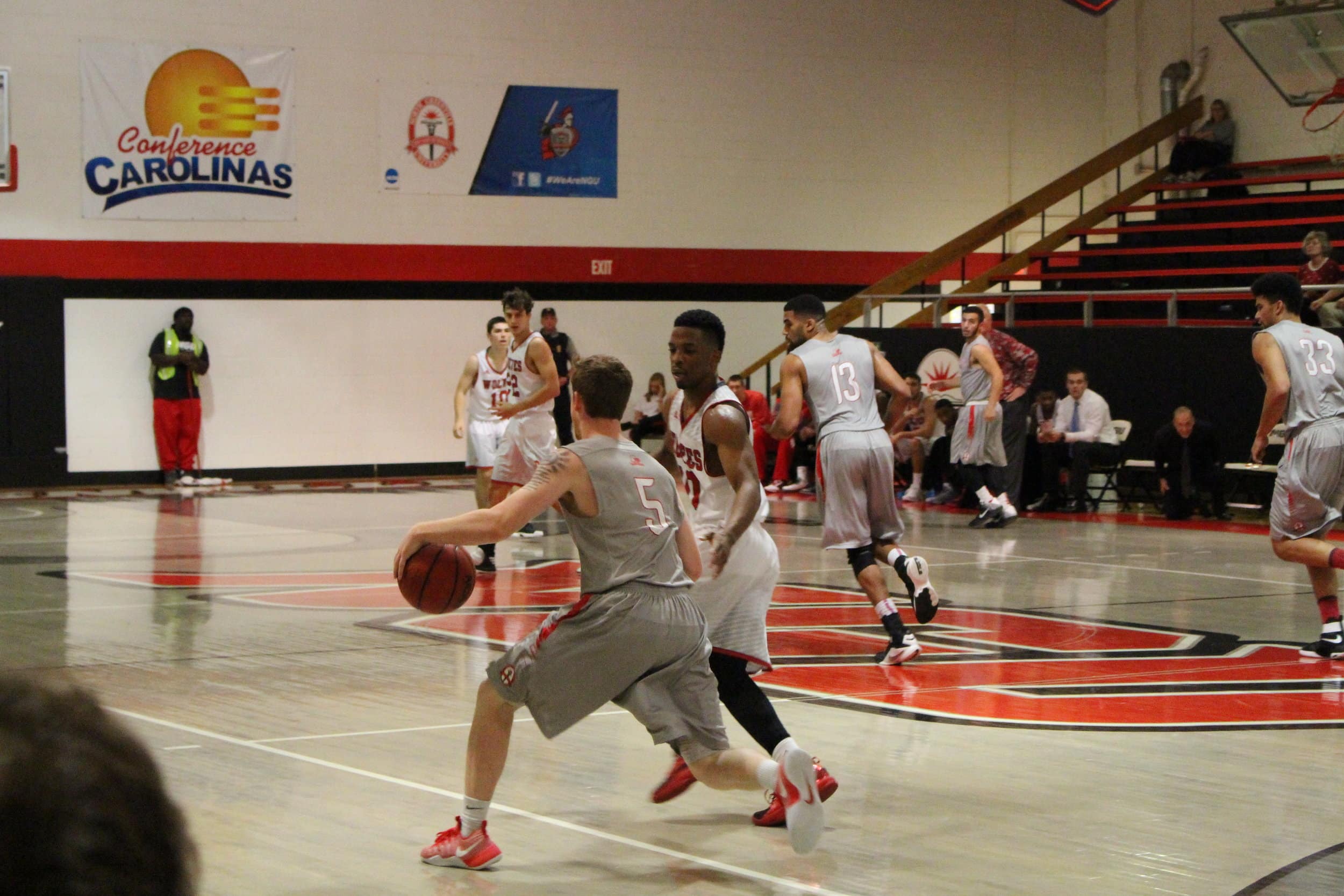  Matt Moore, junior, takes the basketball on down the court.&nbsp; 