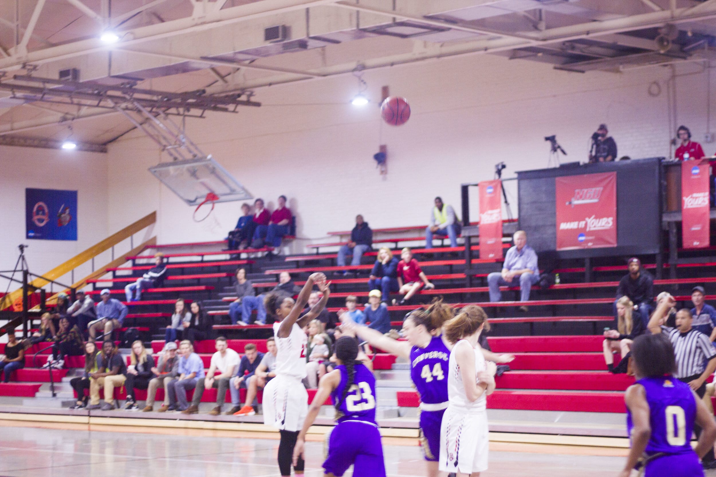 Mychala Wolfe attempts a three-pointer over two Converse defenders.