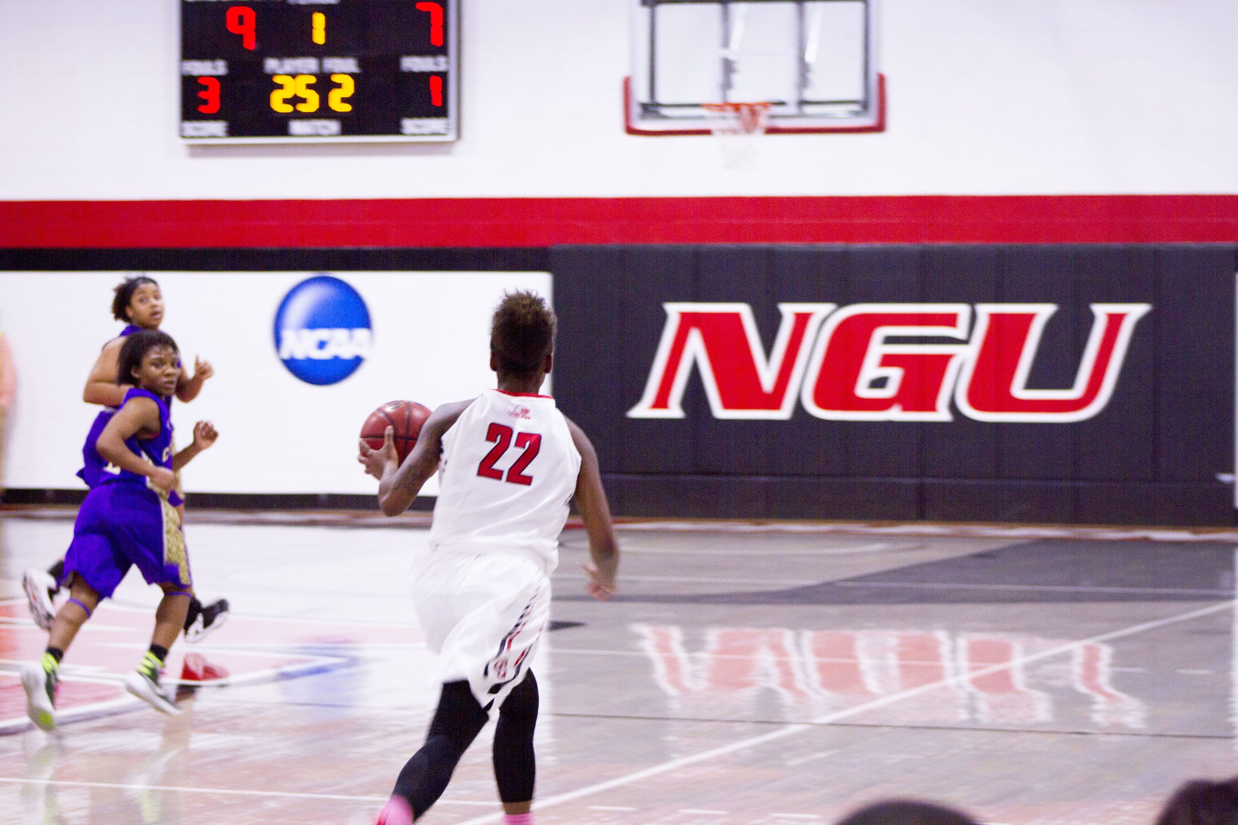 Mychala Wolfe (22) pushes the ball up court on a fast break.