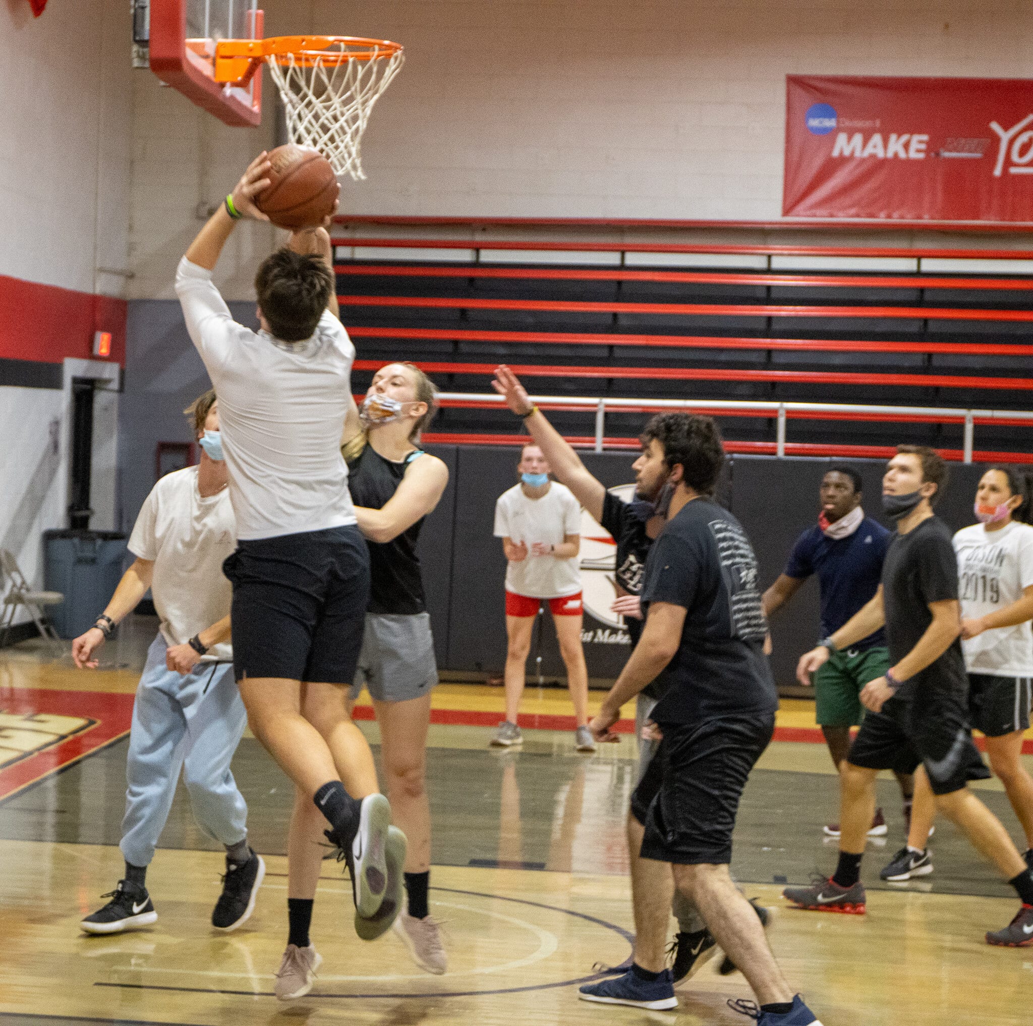 The same student captures everyones attention as he drives into the paint for another layup.
