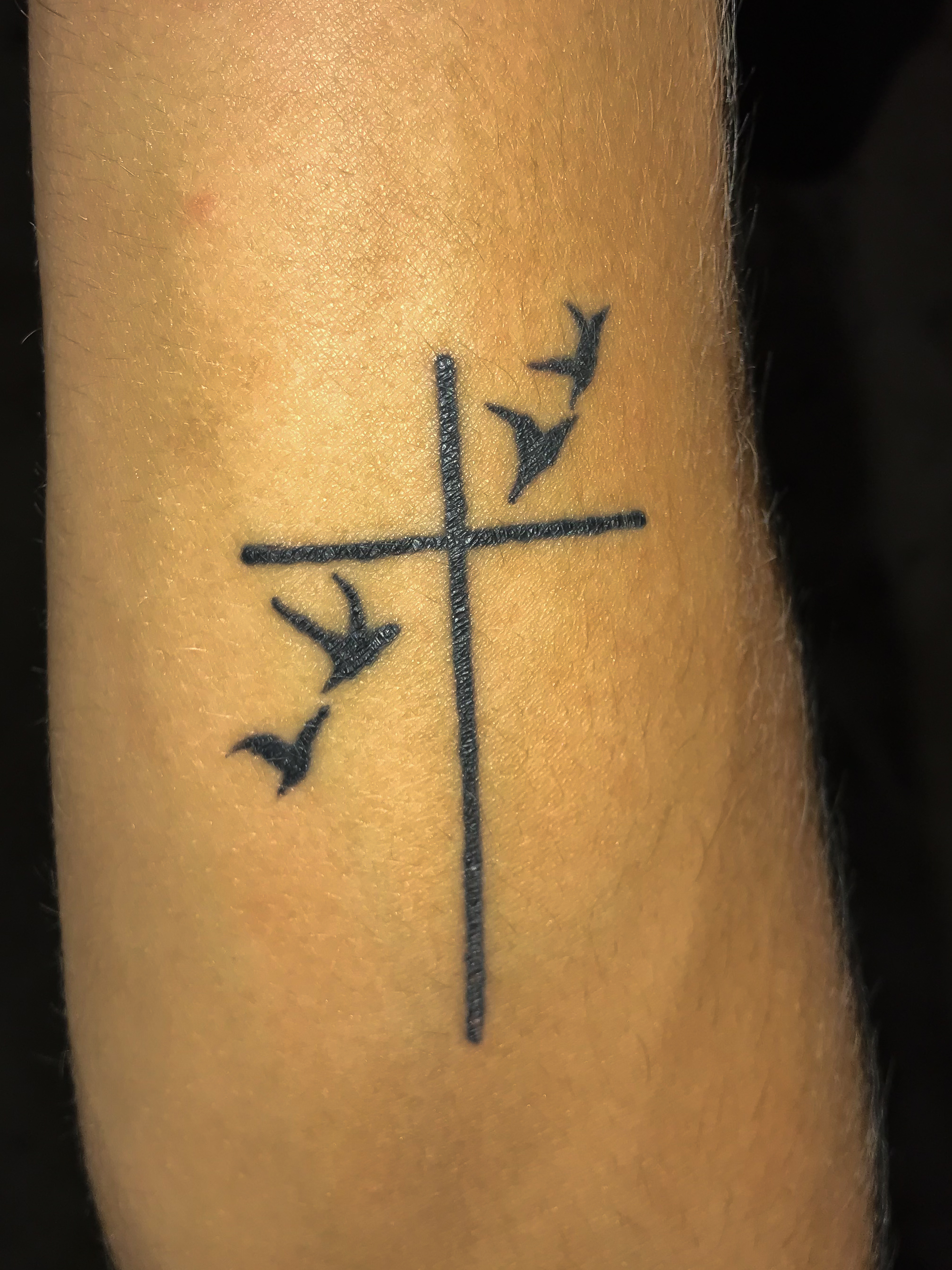 This is Jacob Holcombe. He got this tattoo before he moved to North Greenville. This tattoo symbolizes Holcombes faith and tells others that he is someone you can talk to about Christianity.