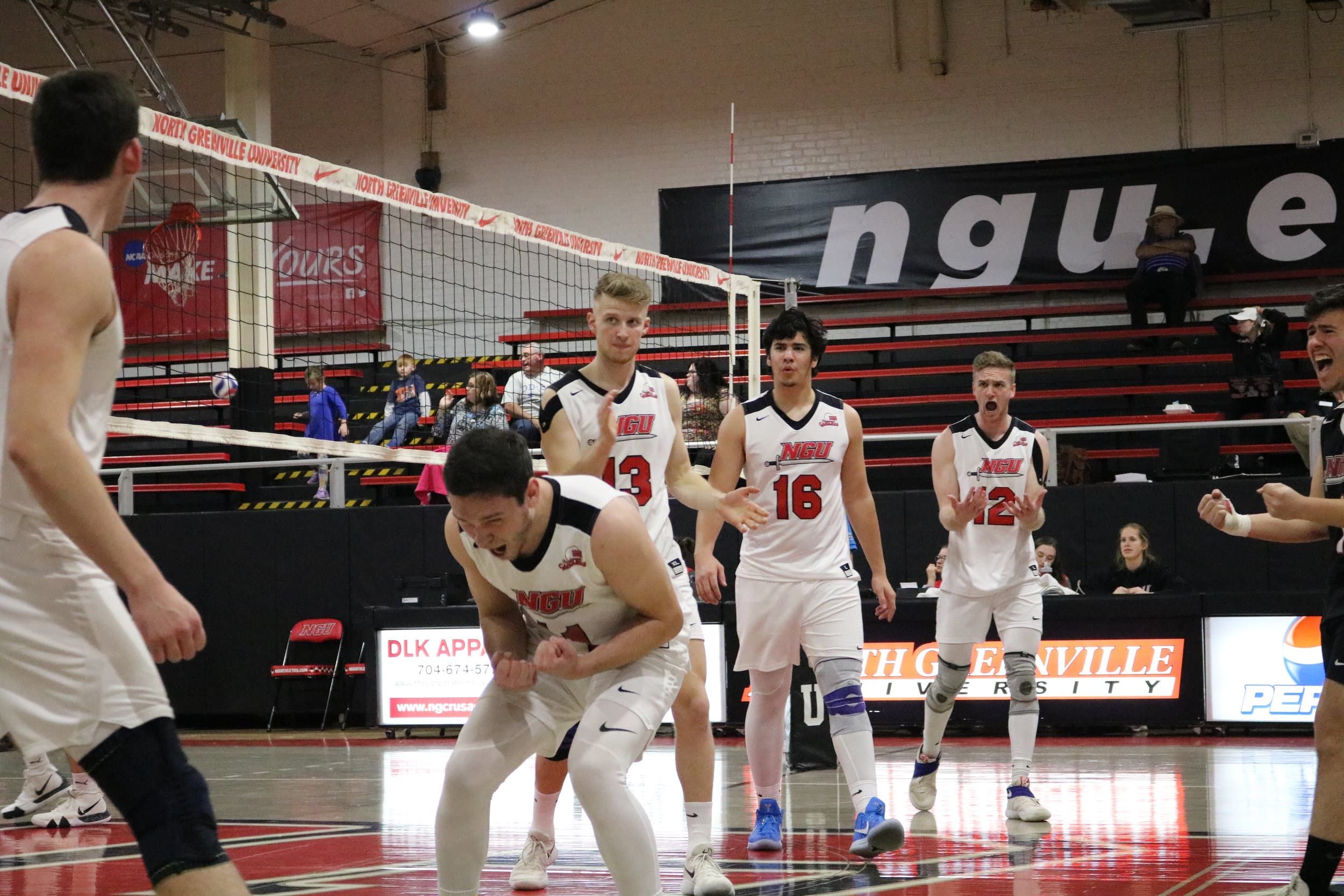 Rojba (1), Gilbert (7), McGee (11), Senior Aaron Campbell (12), Junior Ben Hamsho (13), and Carrillo (16) celebrate after scoring a point at the beginning of the third set.