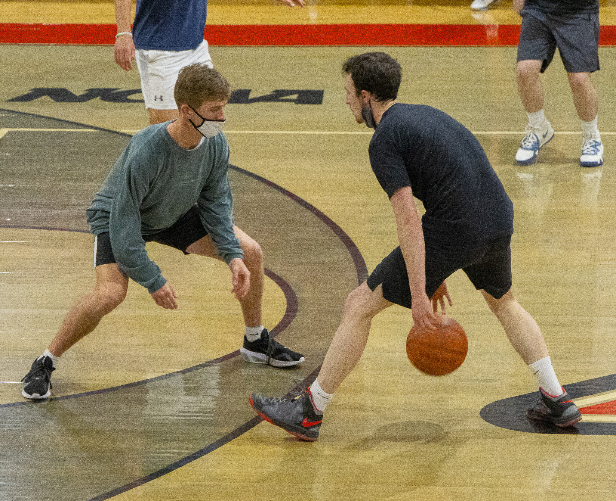 Graduate Assistant Brett Plyler sizes up junior Isaiah Mayhall.