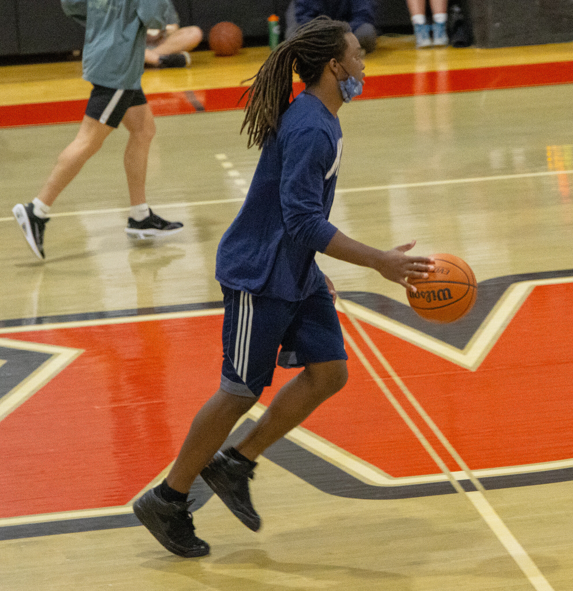 Freshman Khalil Johnson brings the ball up the court.