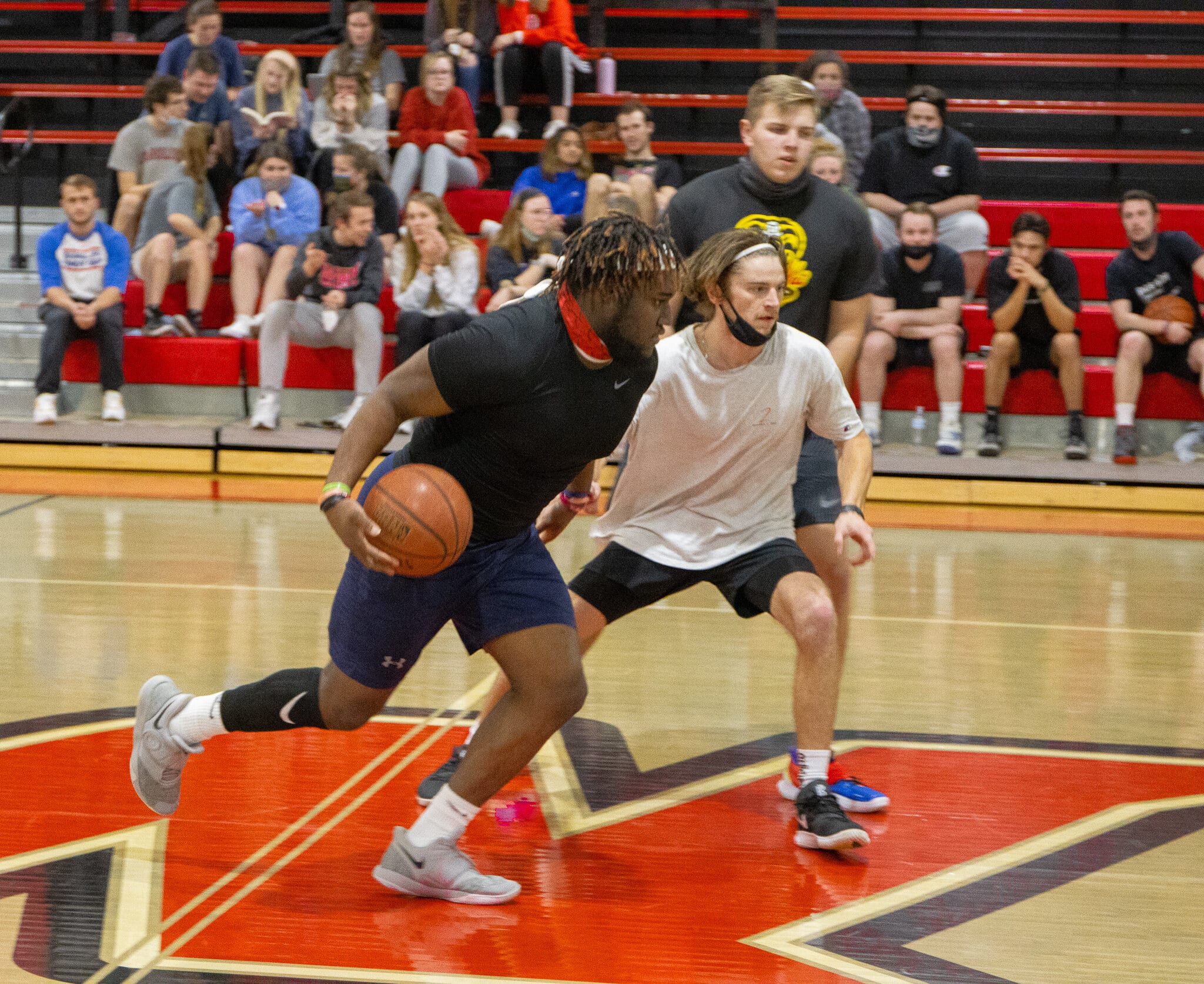 Junior Kwame Livingston drives past junior Drew Reynolds.