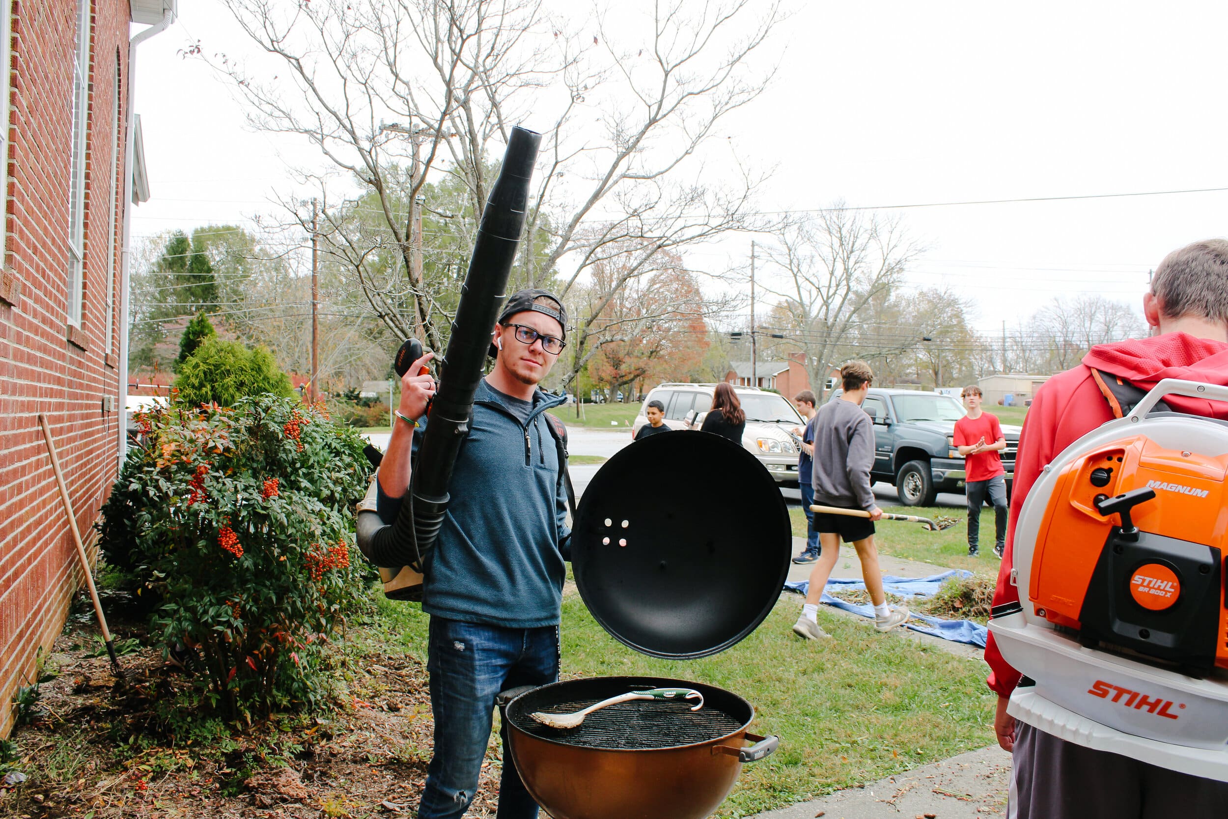 NGU Christian studies major Christian Bowers participates in church-clean up outside.