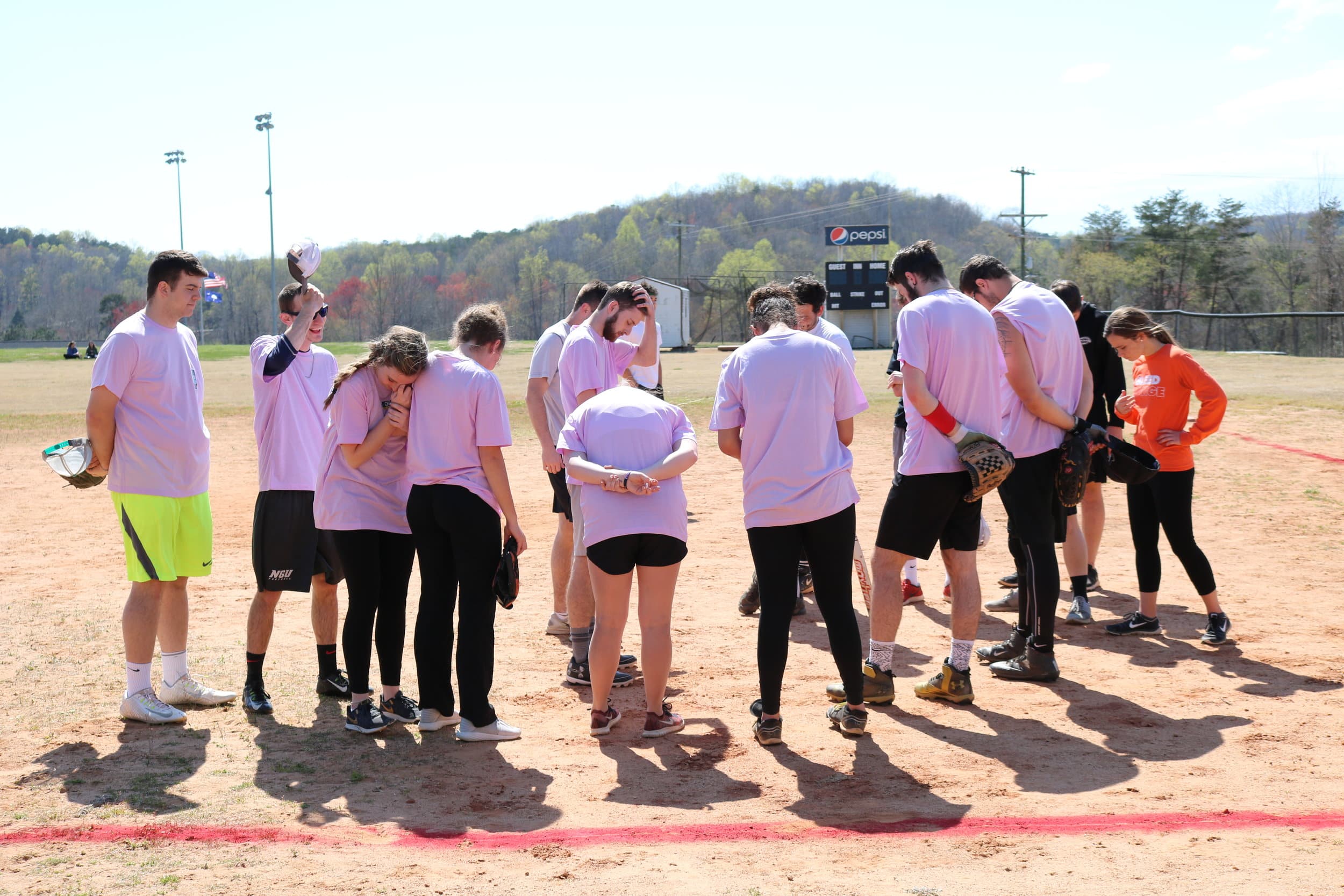 BATsheba ad Pitches Be Crazy come together after their game for a word of prayer.