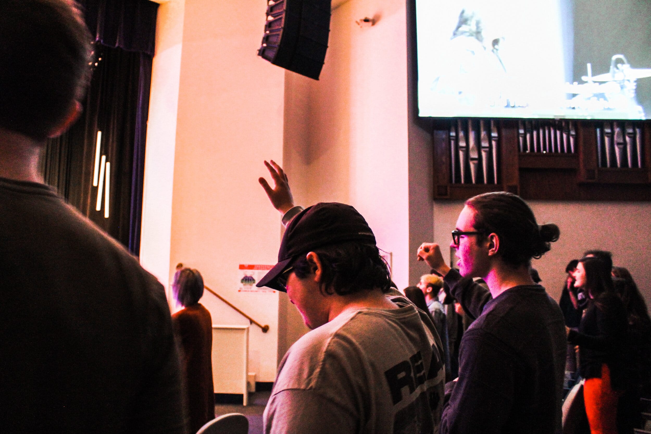 Students lifting their hands in worship.