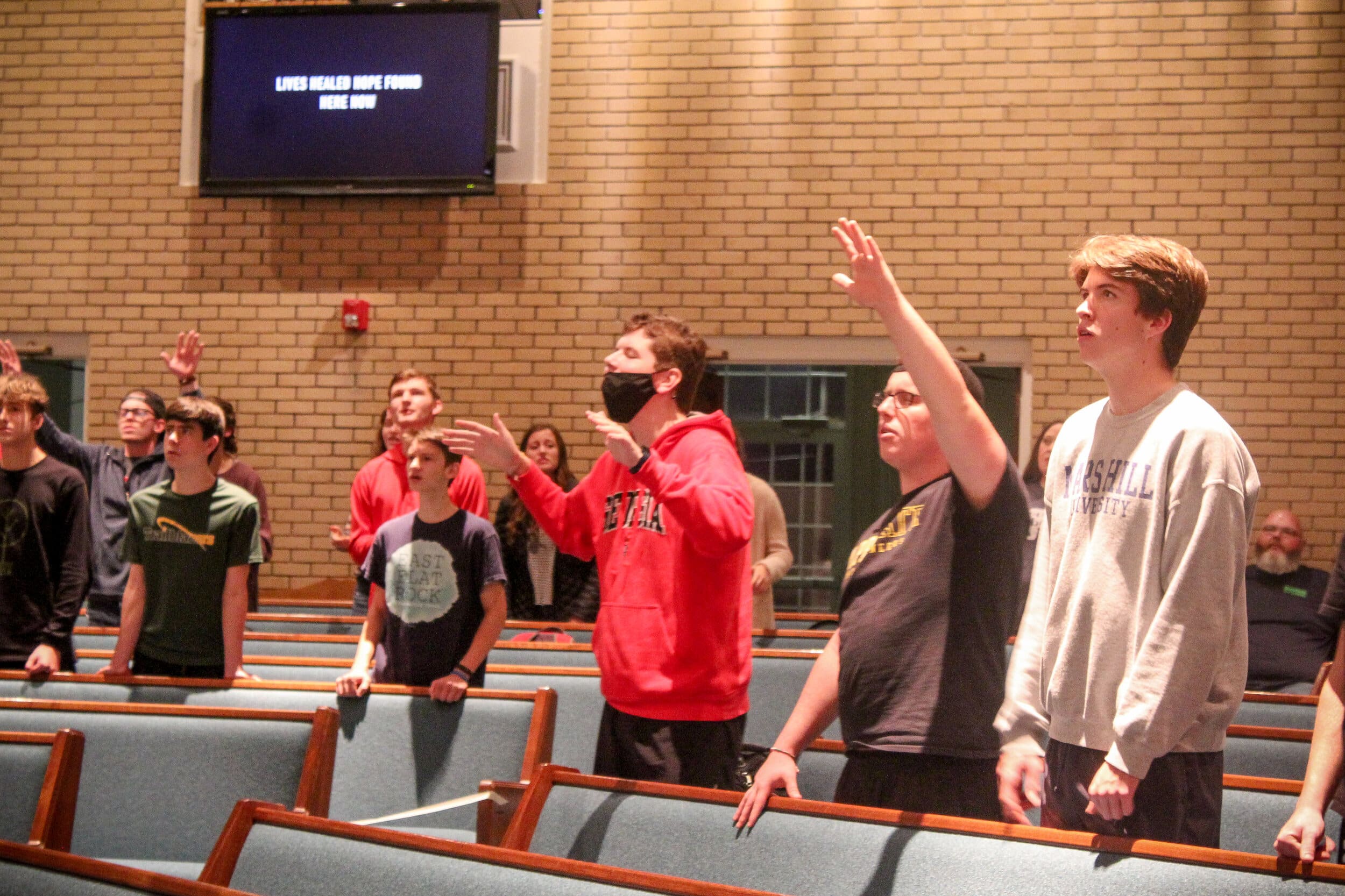 NGU students worship alongside youth group members. Social distancing policies were in place, even within such a large setting, but the gospel message was still received.