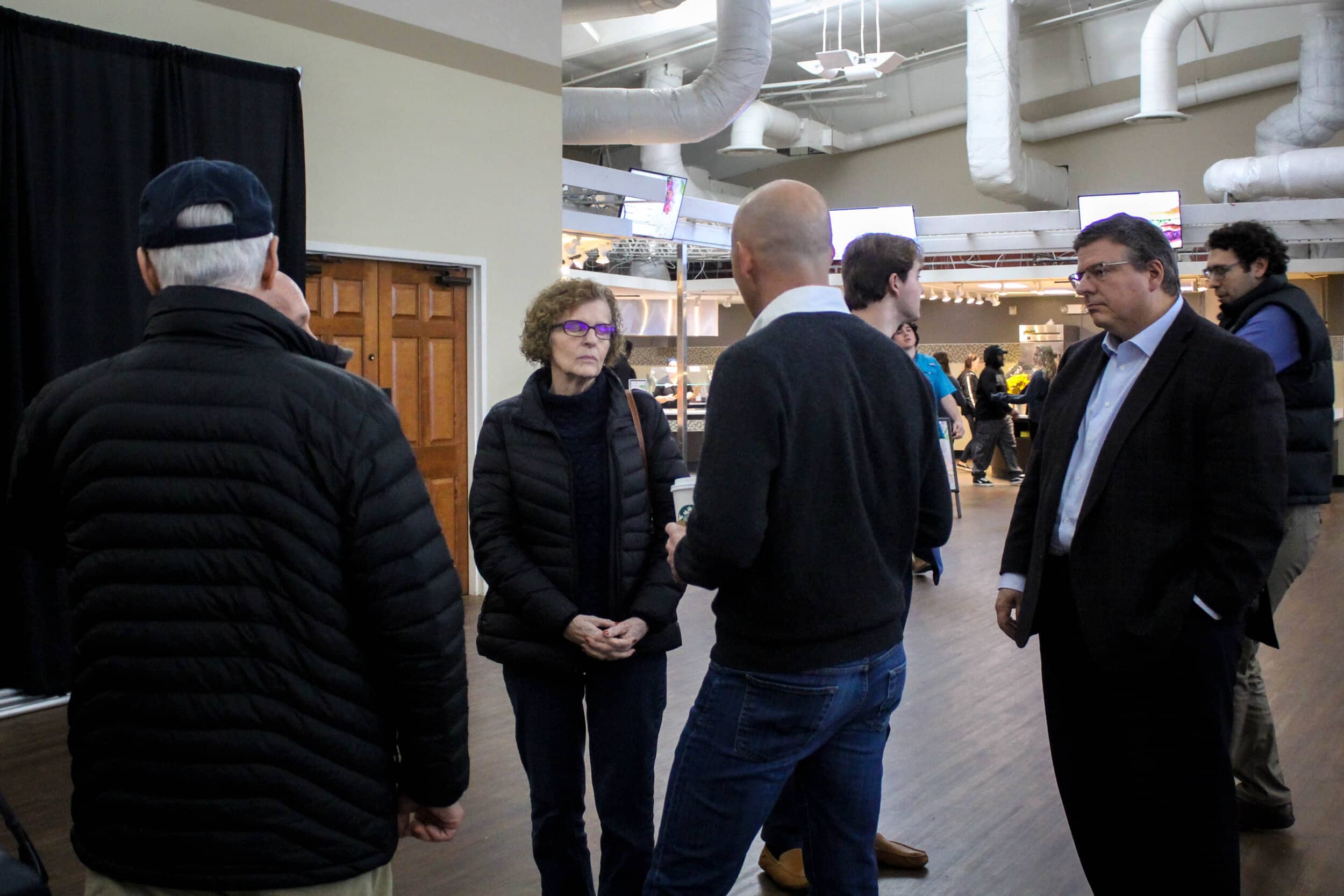 After the town hall meeting, Timmons has conversations with attendees from the community.