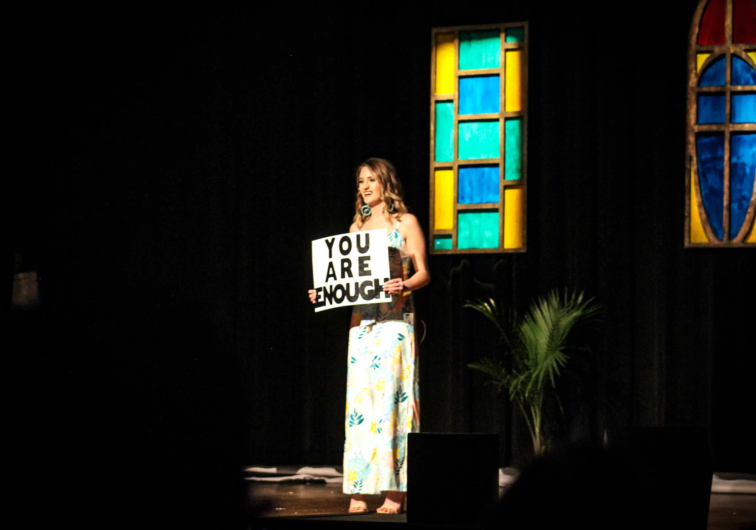 Brooke Biondo, junior contestant of Miss NGU, holding a sign during her encouraging speech during the ballgown section.