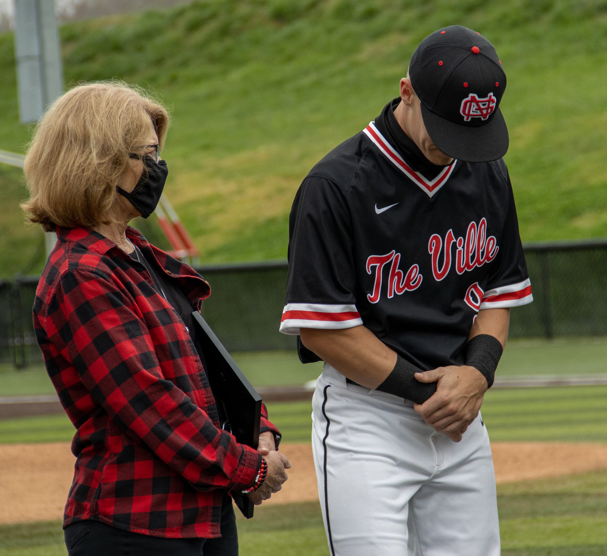 Shortstop Connor Driscoll fights back tears as the seniors are presented to the audience.