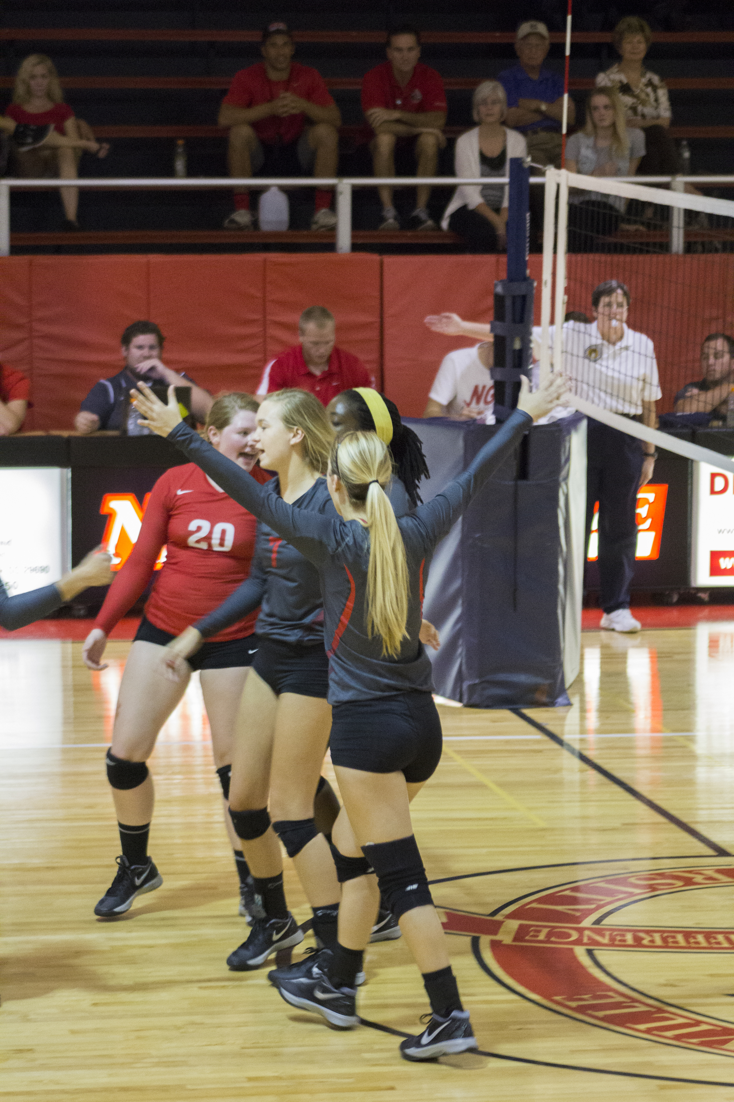  Junior Taylor Dupes, sophomore Haley Hester and junior Hannah Lewis celebrate after winning a point. 