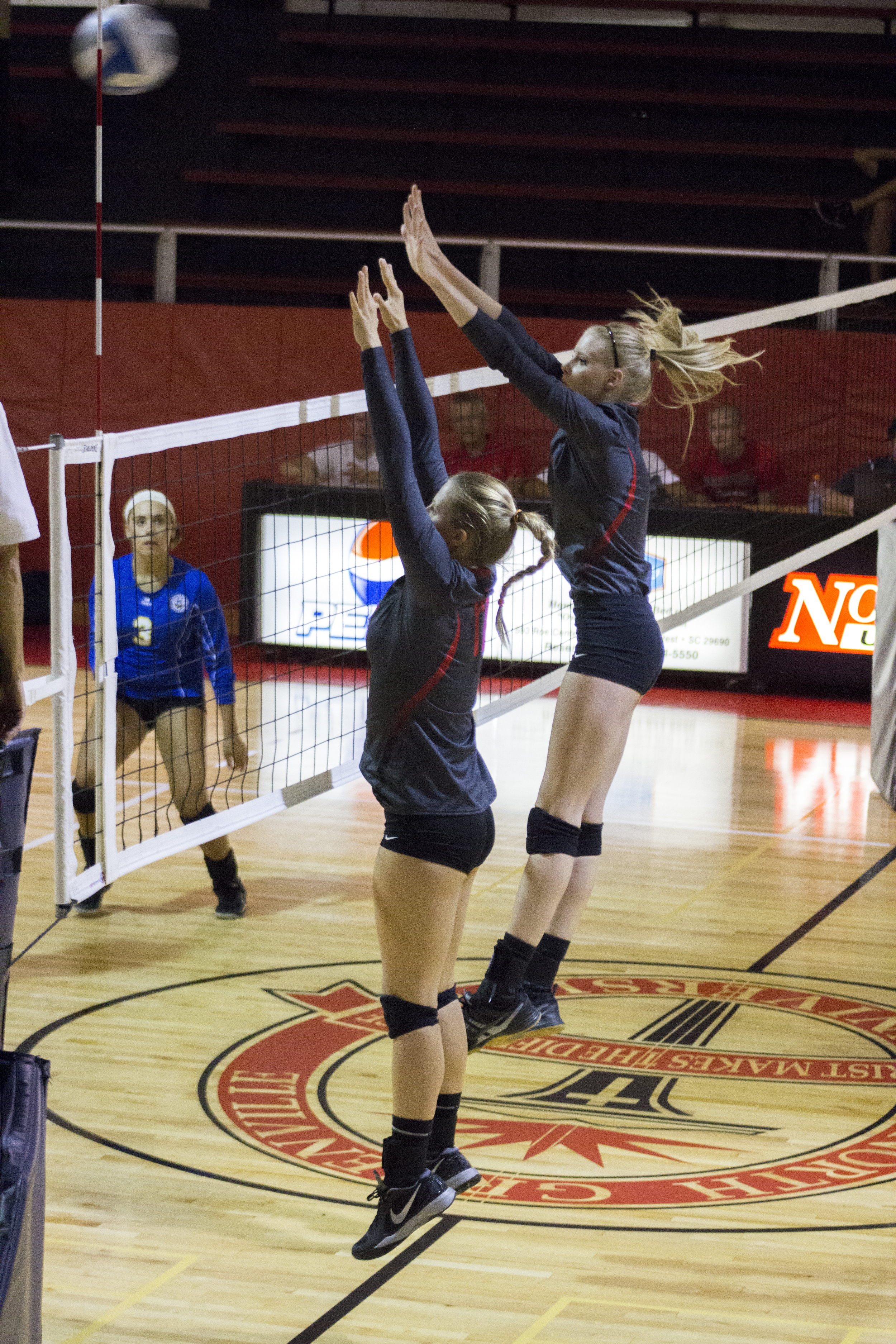  Sophomores Rachel Burts and Hannah Helbert attempt to block a return.&nbsp; 